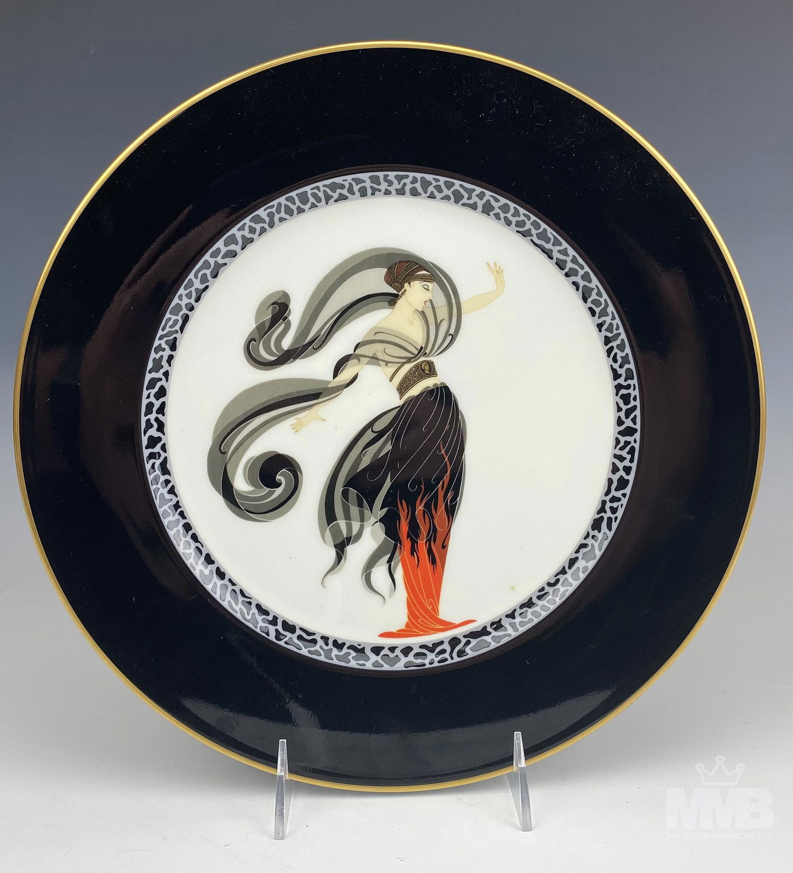 Erte Flames D' Amour Lady Bone China Charger Plate: Erte plate. Titled "Flames d' Amour" . Black rimmed plate of a woman dressed in a black, grey and red elegant ensemble. Good condition, frame having normal storage wear. Measures approximately 12 in.