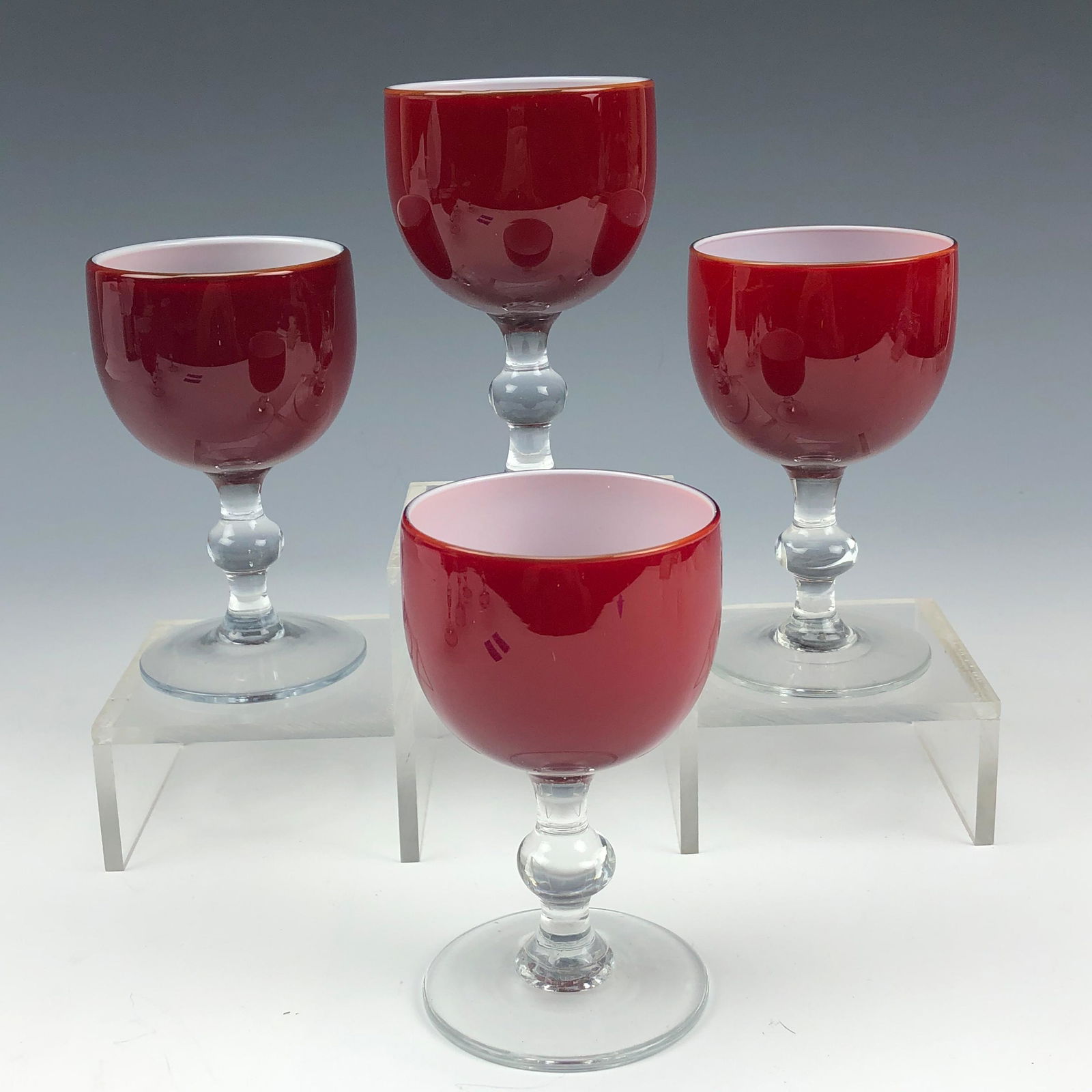 4 Carlo Moretti Mid Century Port Wine Glass Goblet: Established in 1958 in Murano, Venice by brothers Carlo & Giovanni Moretti. Painstakingly mouth blown in manner. Intense blood red exterior masterfully accented by a crisp white cased interior. Clear