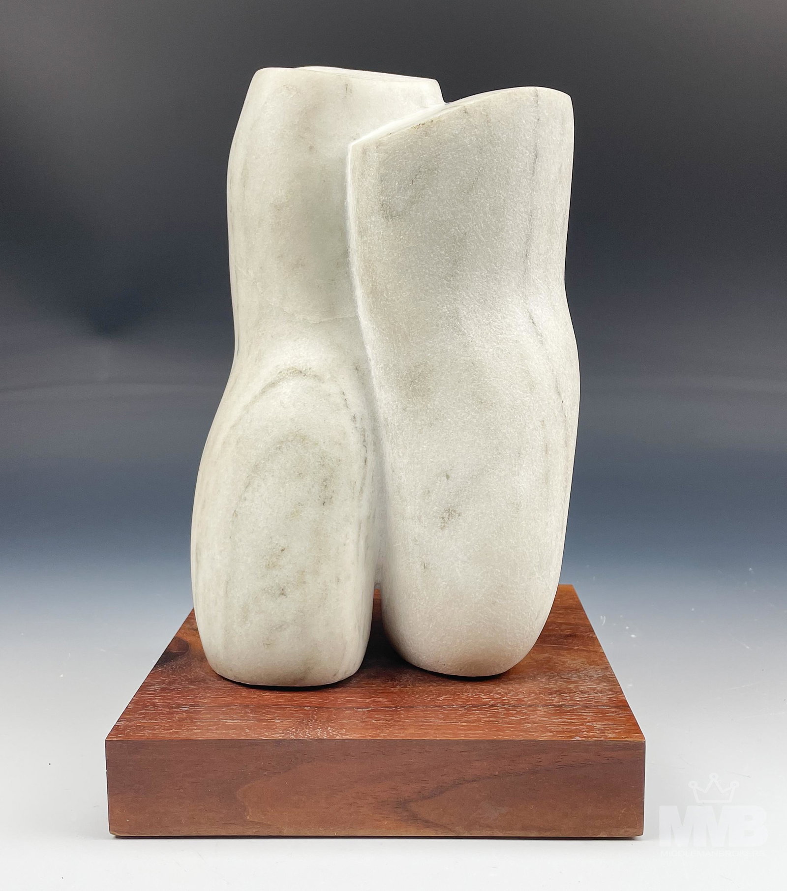 David Wesley Nude Torso Modernist Marble Sculpture: Subject matter is that of the lower torso executed in white marble featuring the legs and buttocks. This smooth polished composition is mounted atop a dark colored solid wooden base. Warm original age