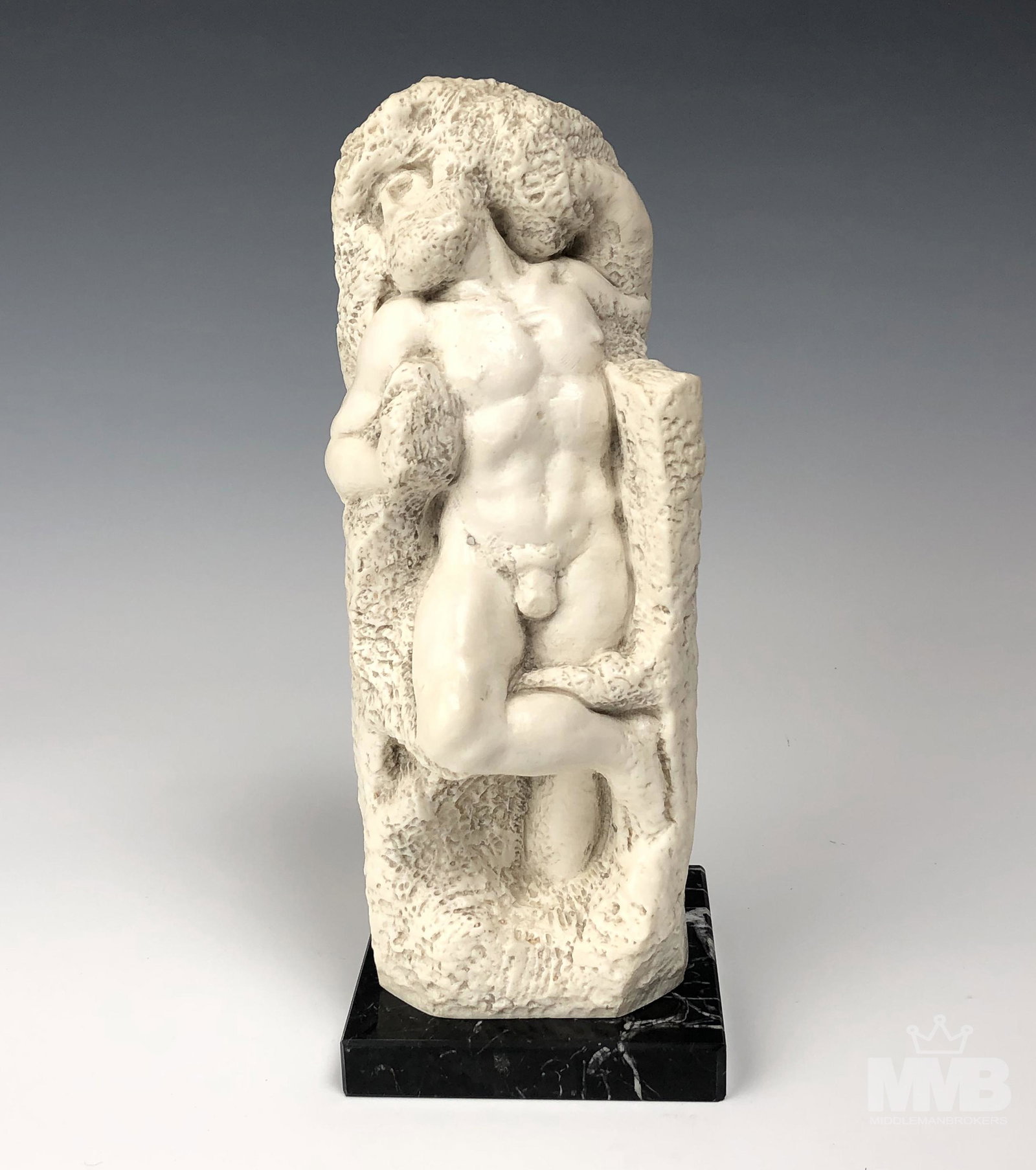 Ruggeri Italian Greco Roman Nude God 10" Sculpture: Gino Ruggeri (Italian, born 1957). Features a standing nude Greco Roman God chiseled in a rock like formation. Work executed in white resin and mounted atop a variegated black marble base. Good condit
