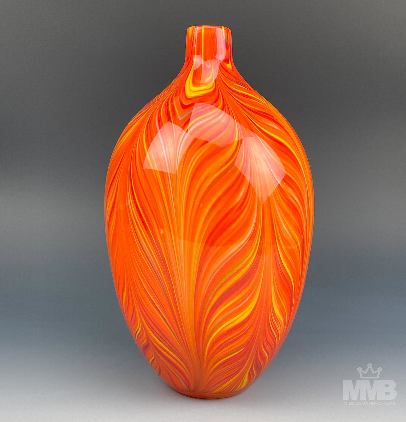 Murano Style Italian Cased Colored Art Glass Vase: Of warm organic inspired form with open mouth over sloped bulbous tapered body. Graced with a multicolored feathered pattern, the interior with white cased coloring. Smooth polished sunk in base. Good