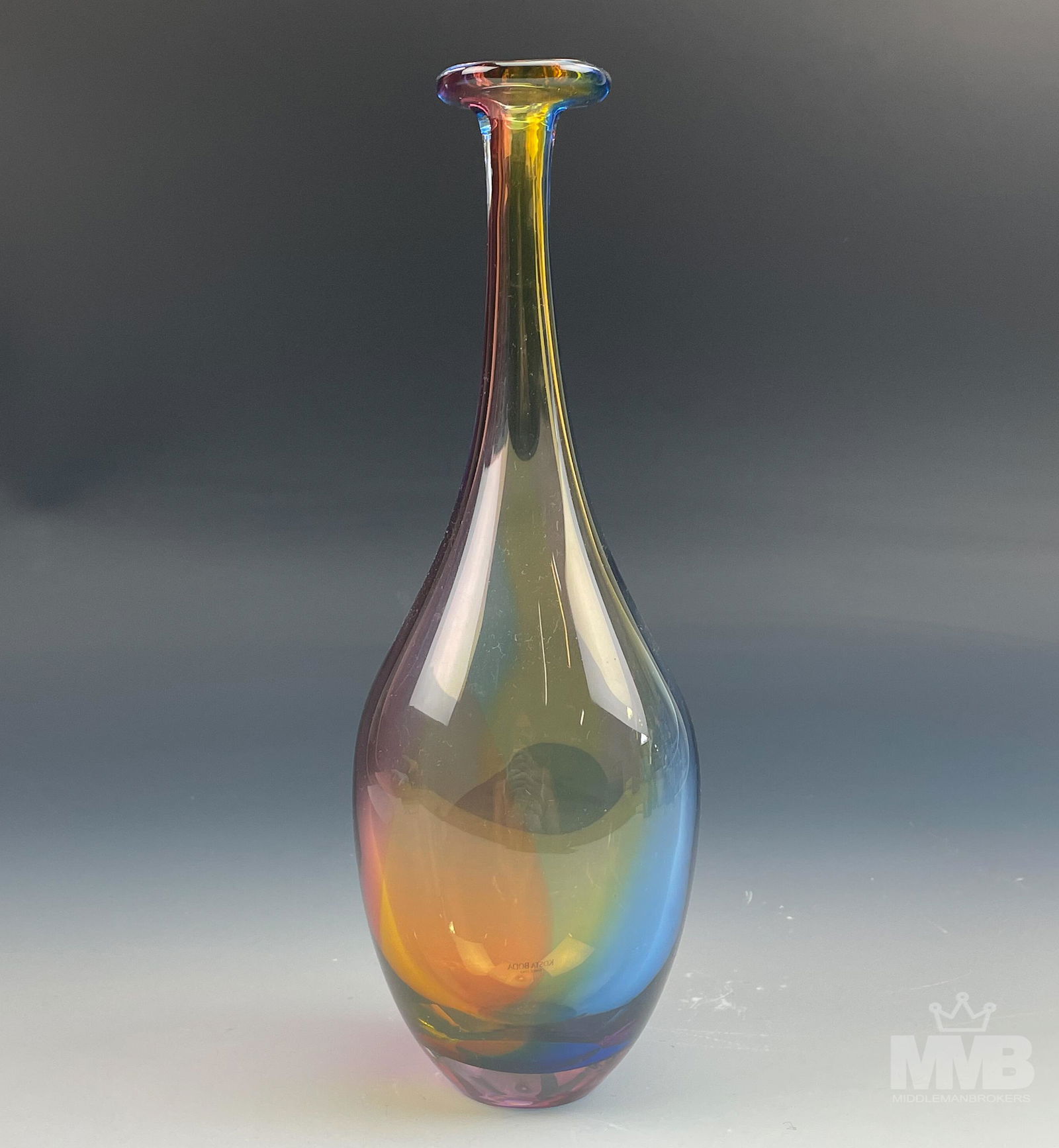 Kosta Boda signed Kjell Engman "Fidji" Glass Vase: This long necked prismatic graceful bottle with it's polychromatic colors was designed by one of Kosta Boda's leading artist Kjell Engman (1946-). Production years for this Fidji model was from 1980 t