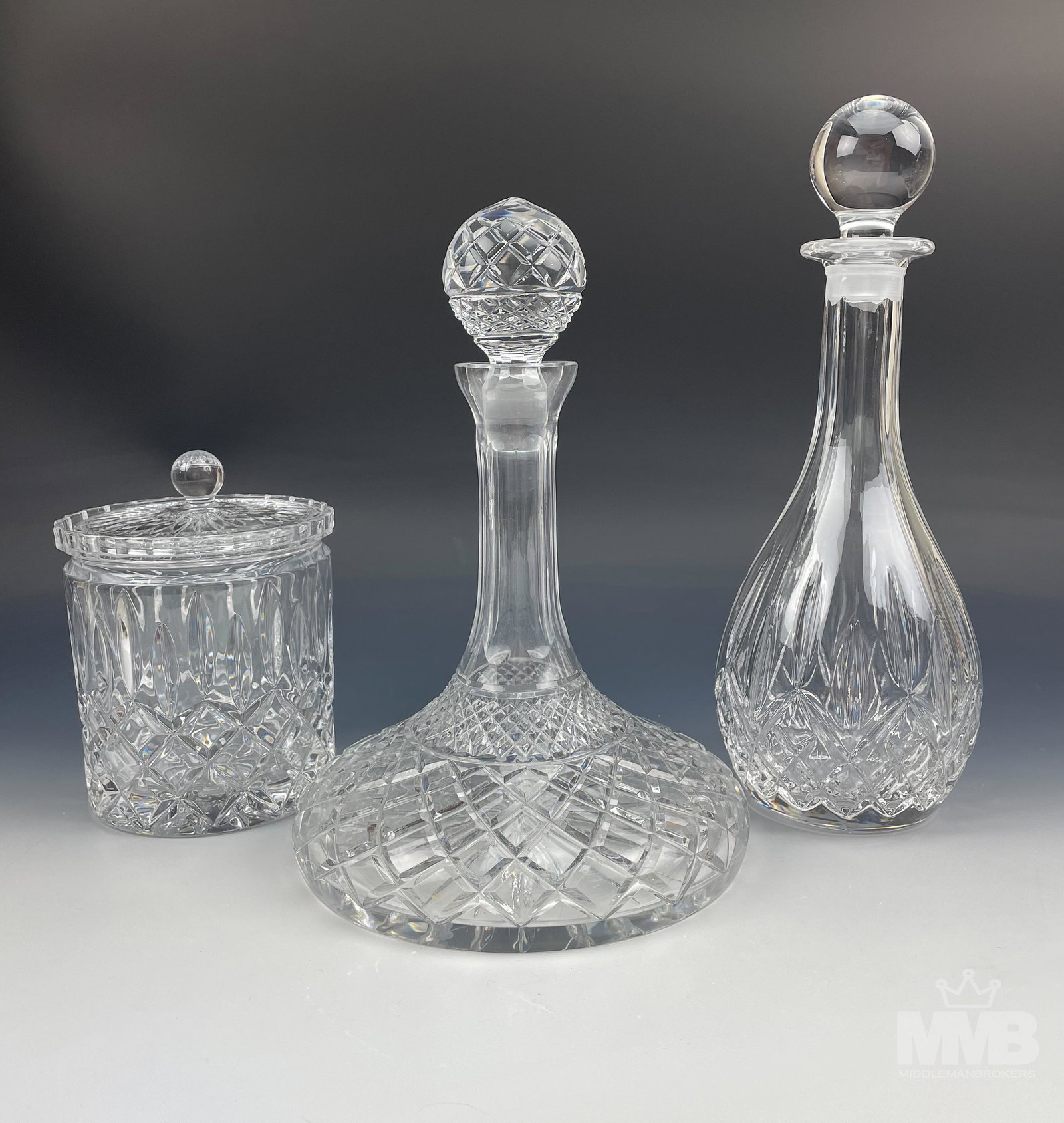 Crystal Ship & Wine Decanters & Biscuit Cookie Jar: This auction is for a crystal glass ships decanter, a wine decanter and a cookie biscuit barrel jar. Design features vertical cuts and diamond quilted patterns. Unsure if the stoppers to the decanter 