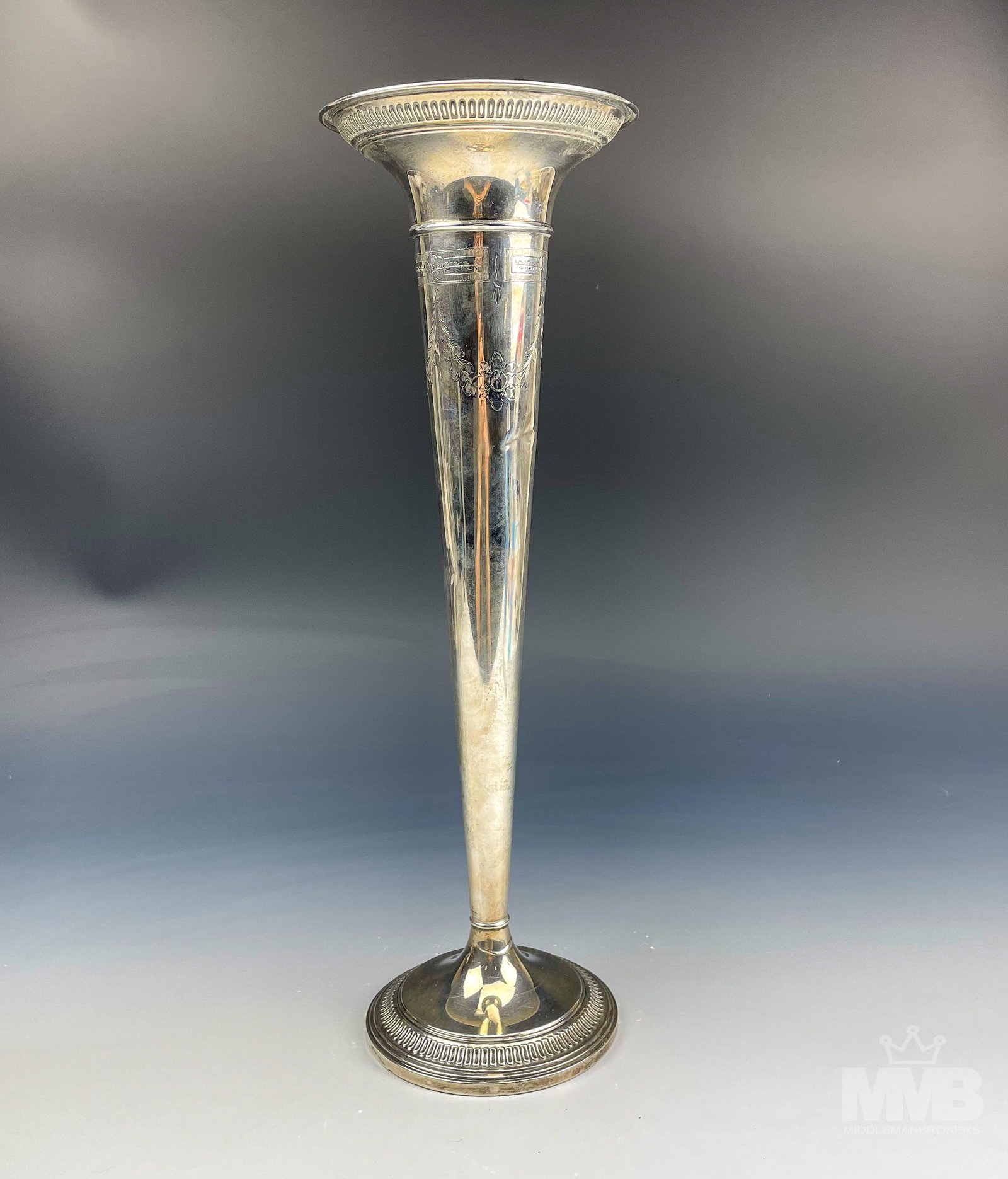 Sterling Silver Art Nouveau Etched Trumpet Vase: Features a sterling silver 925 shelf mantle display vase. Graced with a floral etched pattern on the top, the mouth rim with a gadrooned style border, that is repeated around the stepped circular base