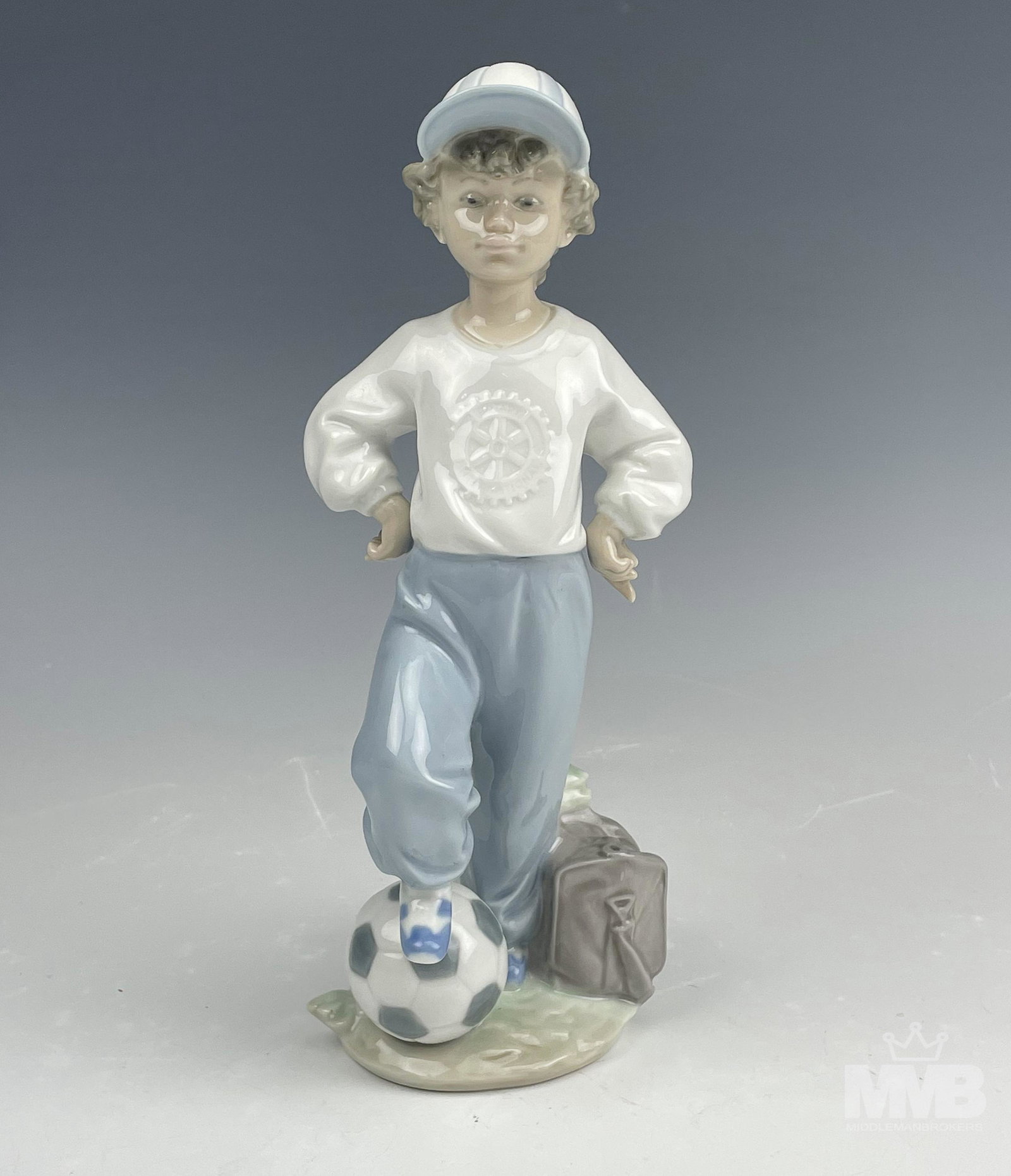 Lladro Starting Forward # 7605 Porcelain Figurine: Lladro Spain "Starting Forward" model number 7605 Hand Painted Glazed Signed Porcelain Figurine. Designed by sculptor Antonio Ramos in 1989. Retired in 2004. Features a young boy with one foot on the 