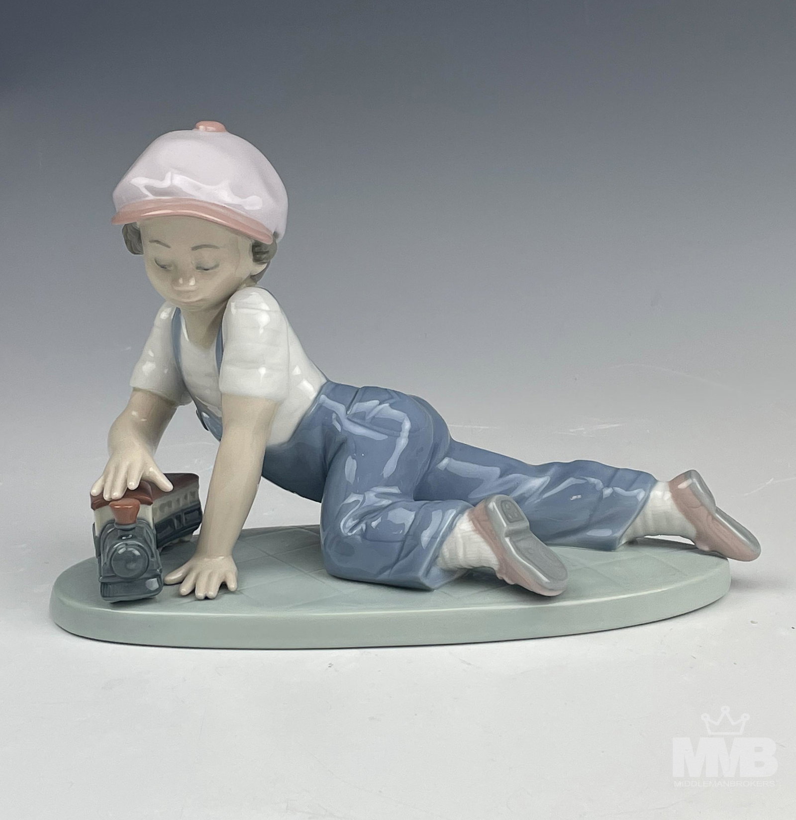 Lladro All Aboard #7619 Boy w/ Toy Train Figurine: Lladro Spain "All Aboard" Model Number 7619 Hand Painted Glazed Signed Porcelain Figurine. Designed by sculptor Antonio Ramos in 1992. Retired in 1995. Features a young boy playing with his toy train.