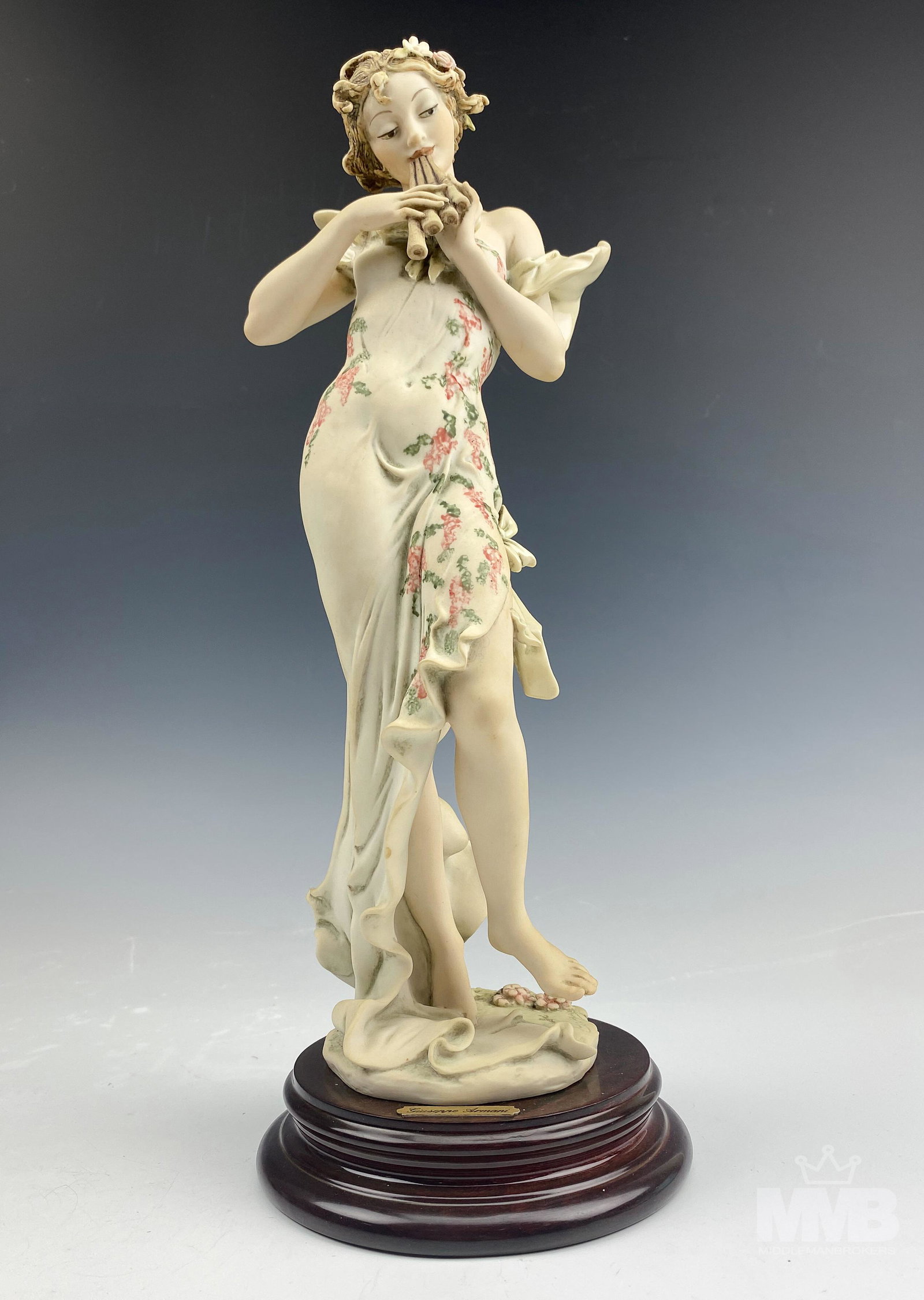 Armani Melody 656C Figurine Lady Playing Pan Flute: Giuseppe Armani Florence Italy Original Figurine. Titled "Melody". Model number 656C. Features a young slender maiden wearing a tight hugging frilly dress, standing bare foot, playing the pan flute. M