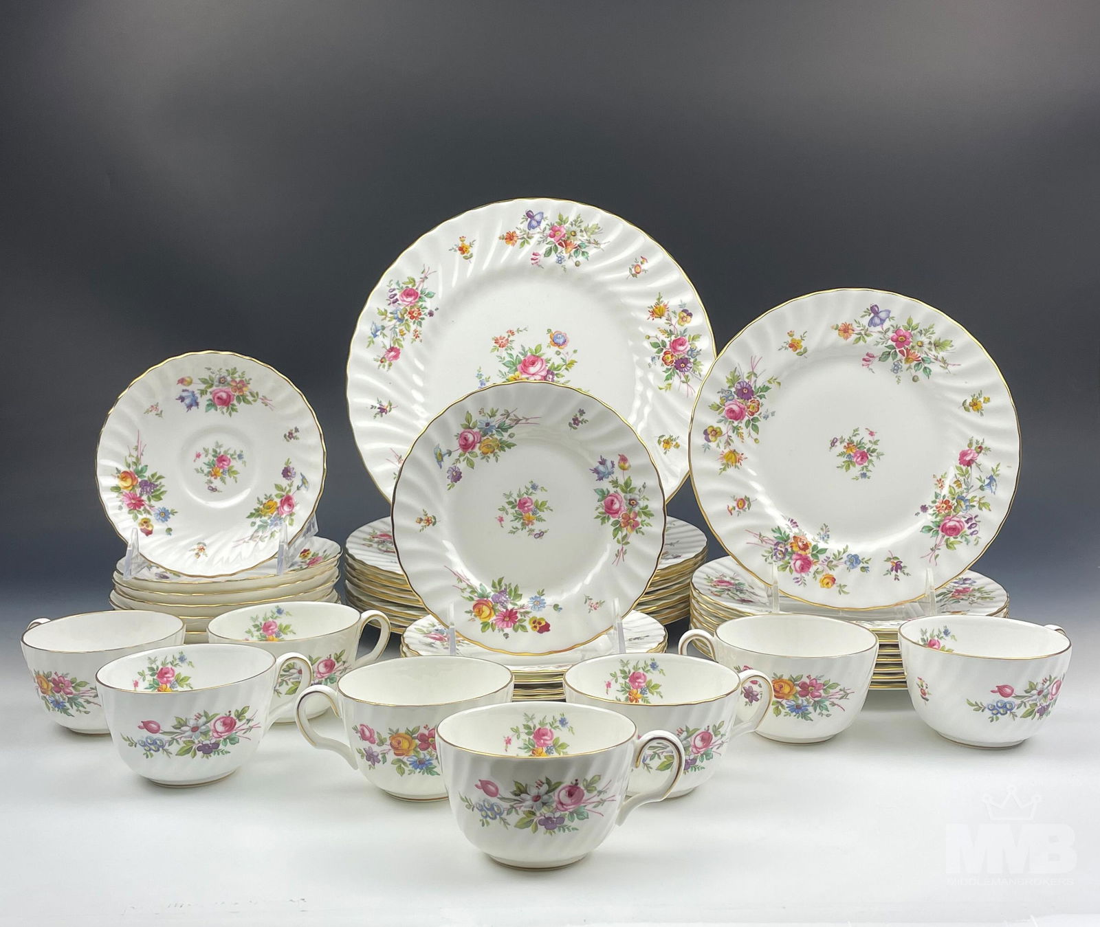 40 pc Royal Minton Marlow Floral Bone China Set: Collection of 40 pieces of Royal Minton fine bone china in the pattern of "Marlow". Features floral design on a white ground with a gold gilt trim. Set includes: (16 total, 8 sets) tea cup and saucers