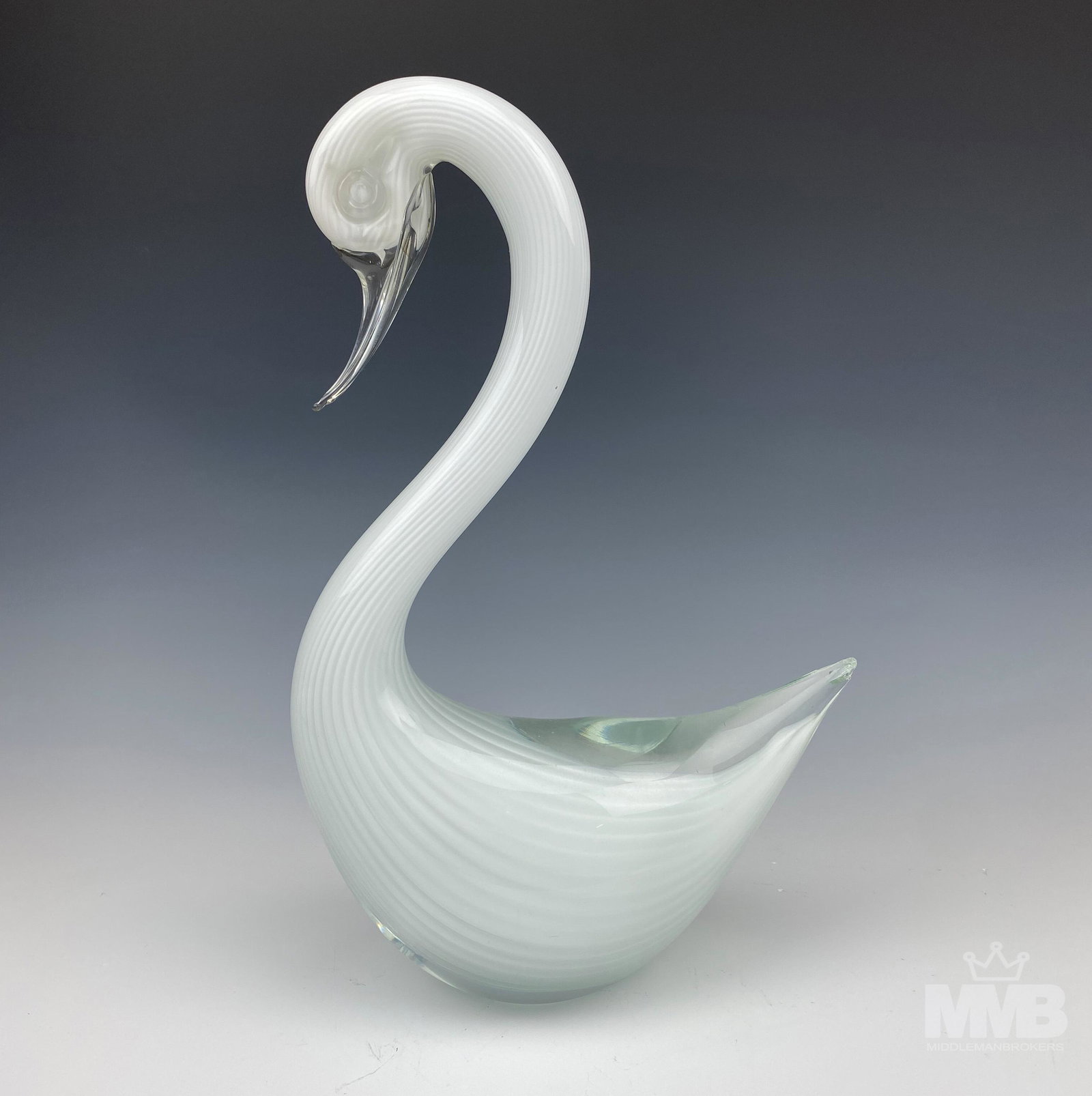 Murano Mid Century Cased Art Glass Swan Sculpture: Murano Italy studio hand blown cased Italian art glass swan bird sculpture. Graced with a white fluted design that is masterfully encased in clear molten crystal/ Clear glass beak and eyes. Smooth mir