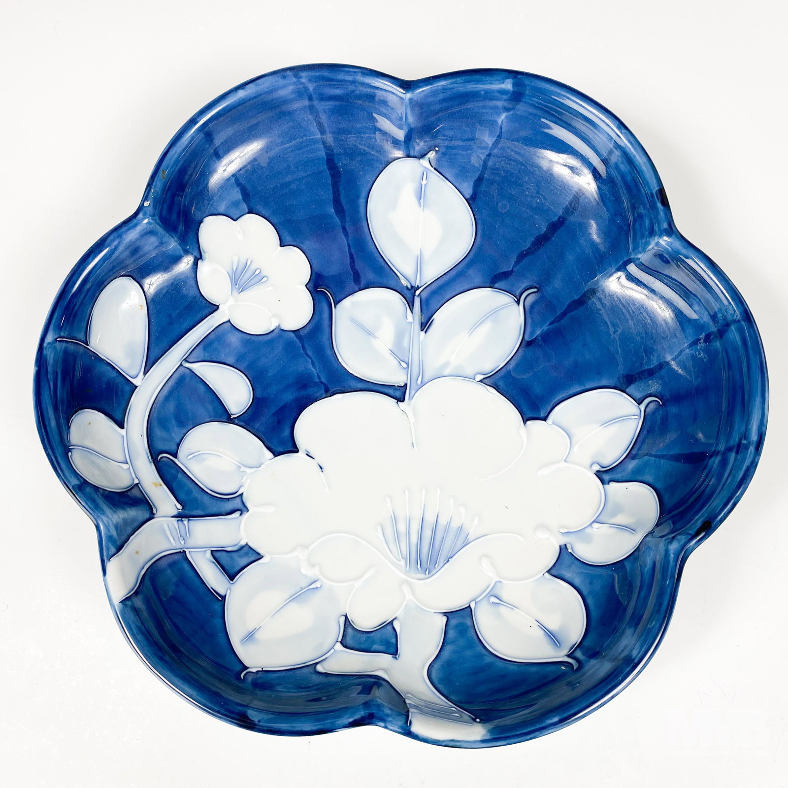 Japanese Porcelain Painted Floral Scalloped Bowl: Depicts a poppy style floral hand painted decoration on this scalloped footed bowl in white with raised enamel accents against a blue striped ground. Warmly glazed in manner. Good estate fresh conditi