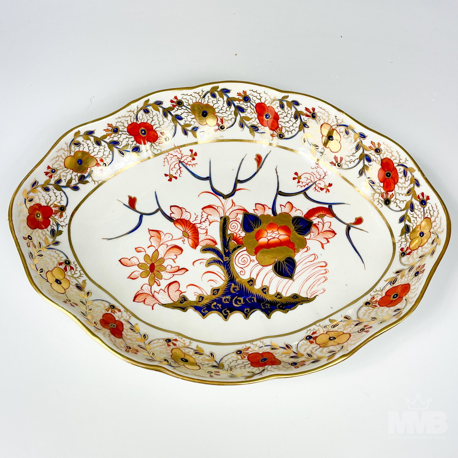 Royal Crown Derby Style Imari Oval Vegetable Bowl: Offered for auction is a bone china oval serving vegetable meat serving bowl. Modeled in the style of Royal Crown Derby with a painted palette of rich cobalt blues and rusts and graced with gold embel