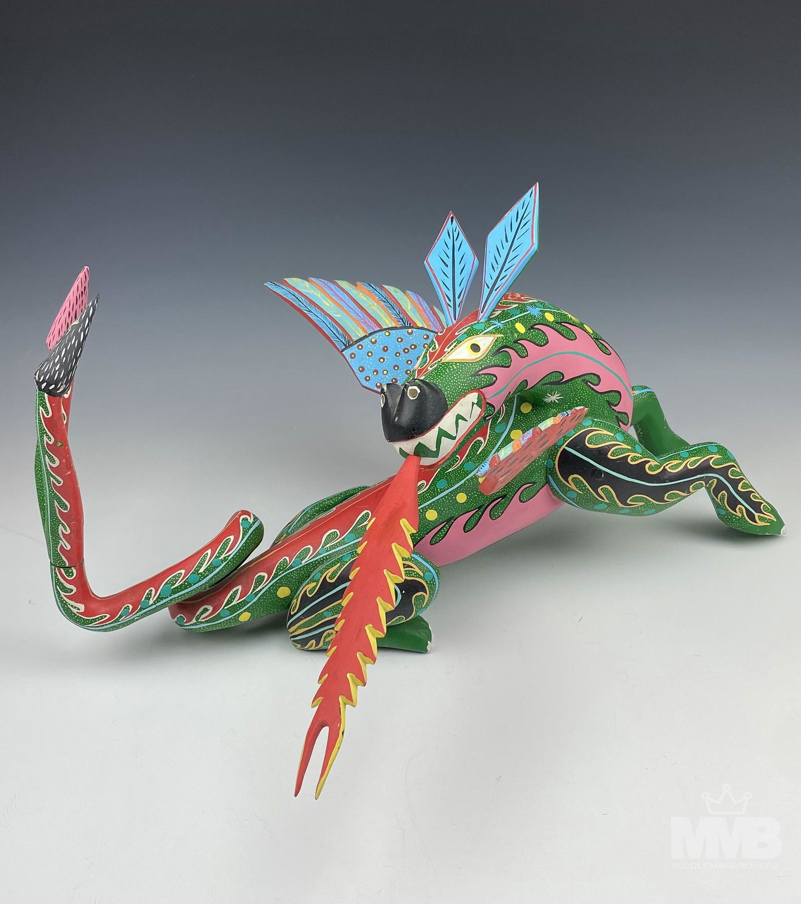 Oaxaca Mexico Folk Art Copal Wood Dragon Sculpture: Fantastic hand carved and hand painted Mexican folk art carved wooden dragon sculpture. Sculpted by artist Eloy Pinis Lopez in his Arrazola gallery in Oaxaca. Design features a stylized mythological a