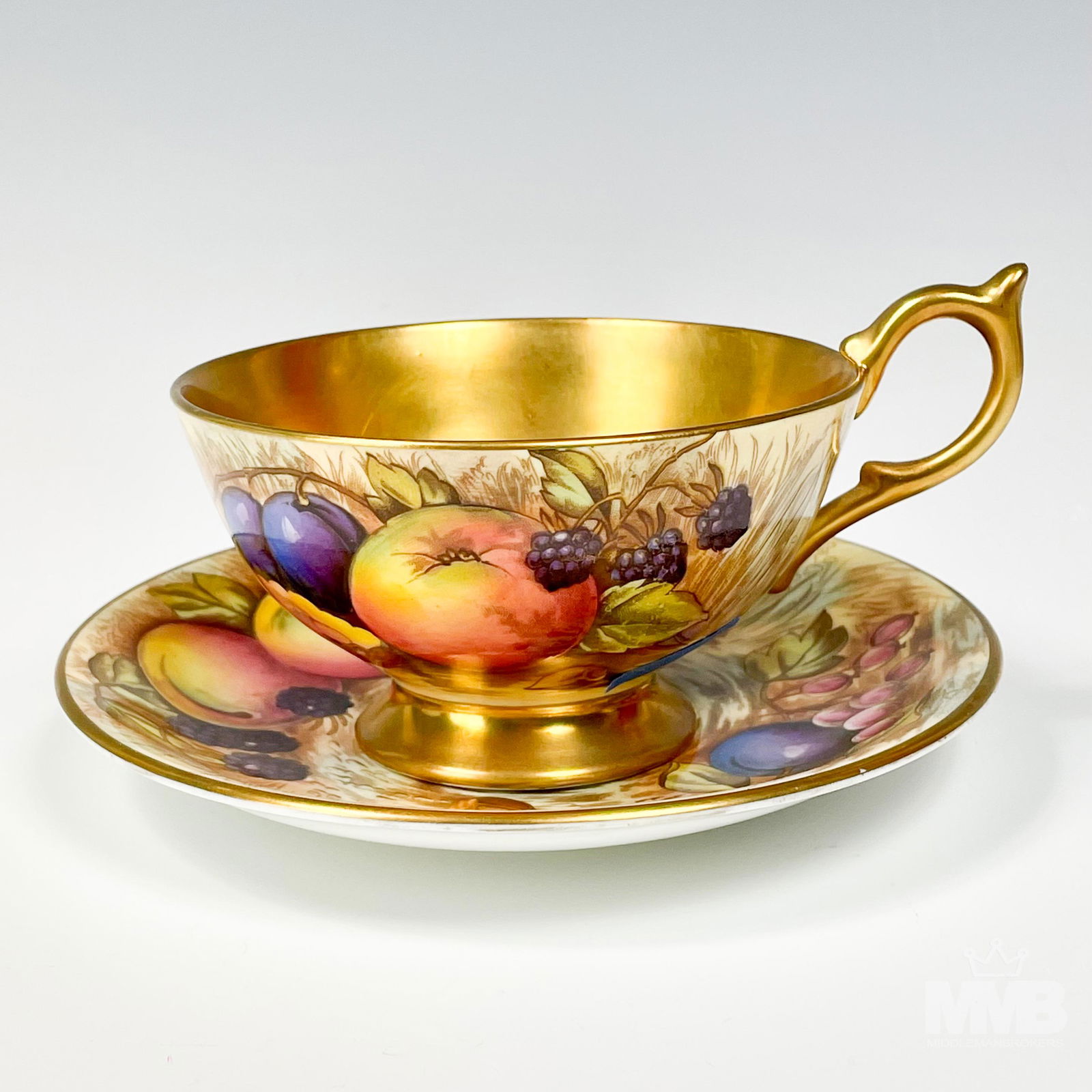 Aynsley Orchard Gold Cabinet Tea Cup & Saucer Set: Aynsley England fine English bone china cabinet display tea cup and saucer set. Modeled in their "Orchard Gold" pattern that was introduced in 1989. Discontinued / retired in 2015. Graced with lusciou