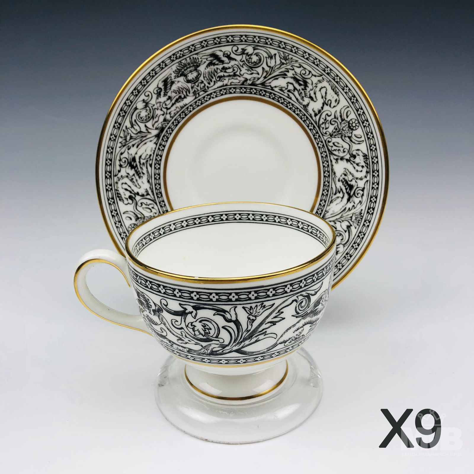 Set 8 Wedgwood Black Florentine Tea Cups & Saucers: Each graced with mythological dragons, phoenix birds and floral decorations around the border, against a crisp white ground with gold trimmed accent linings. Production years : 1959 - 1997. Glazed fin