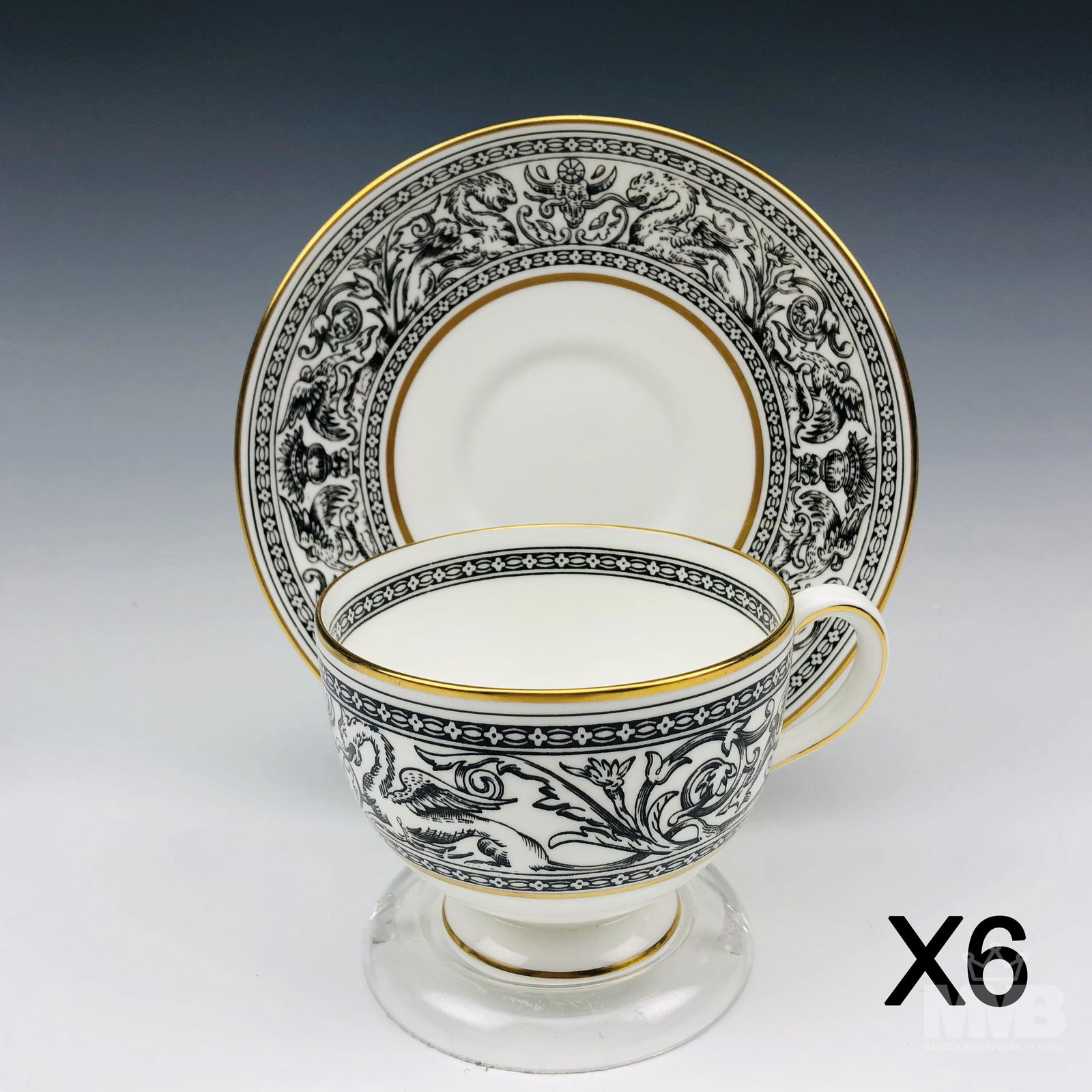 Set 6 Wedgwood Florentine Black Tea Cups & Saucers: Each graced with mythological dragons, phoenix birds and floral decorations around the border, against a crisp white ground with gold trimmed accent linings. Production years : 1959 - 1997. Glazed fin