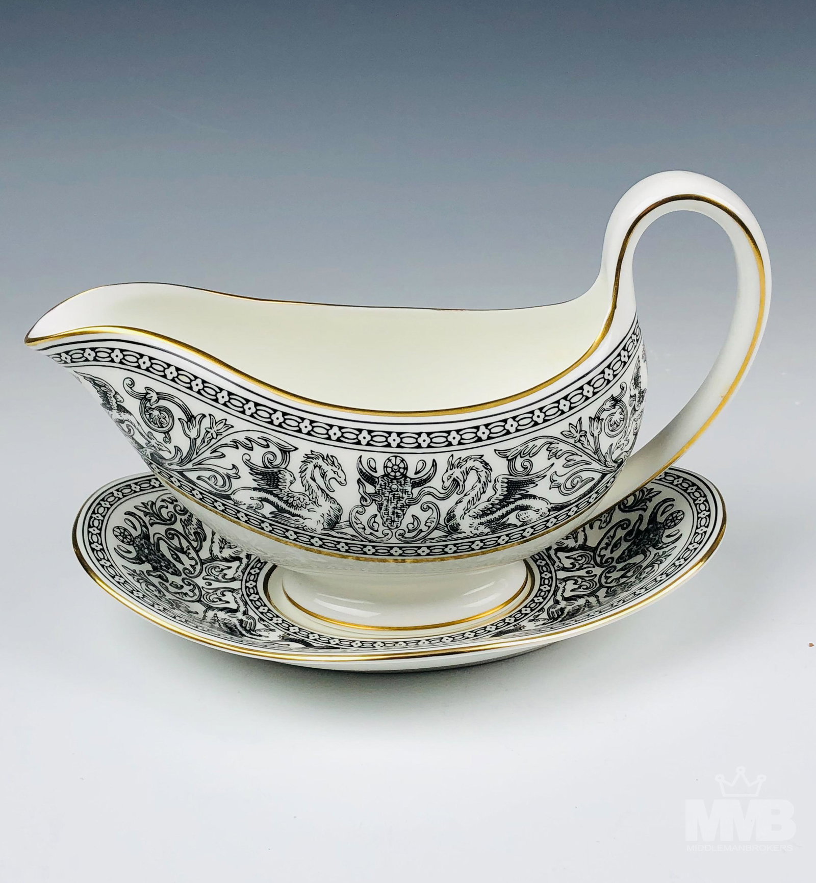 Wedgwood Florentine Black Gravy Boat w Underplate: Each graced with mythological dragons, phoenix birds and floral decorations around the border, against a crisp white ground with gold trimmed linings. Production years 1959 - 1997. Glazed finish. Good