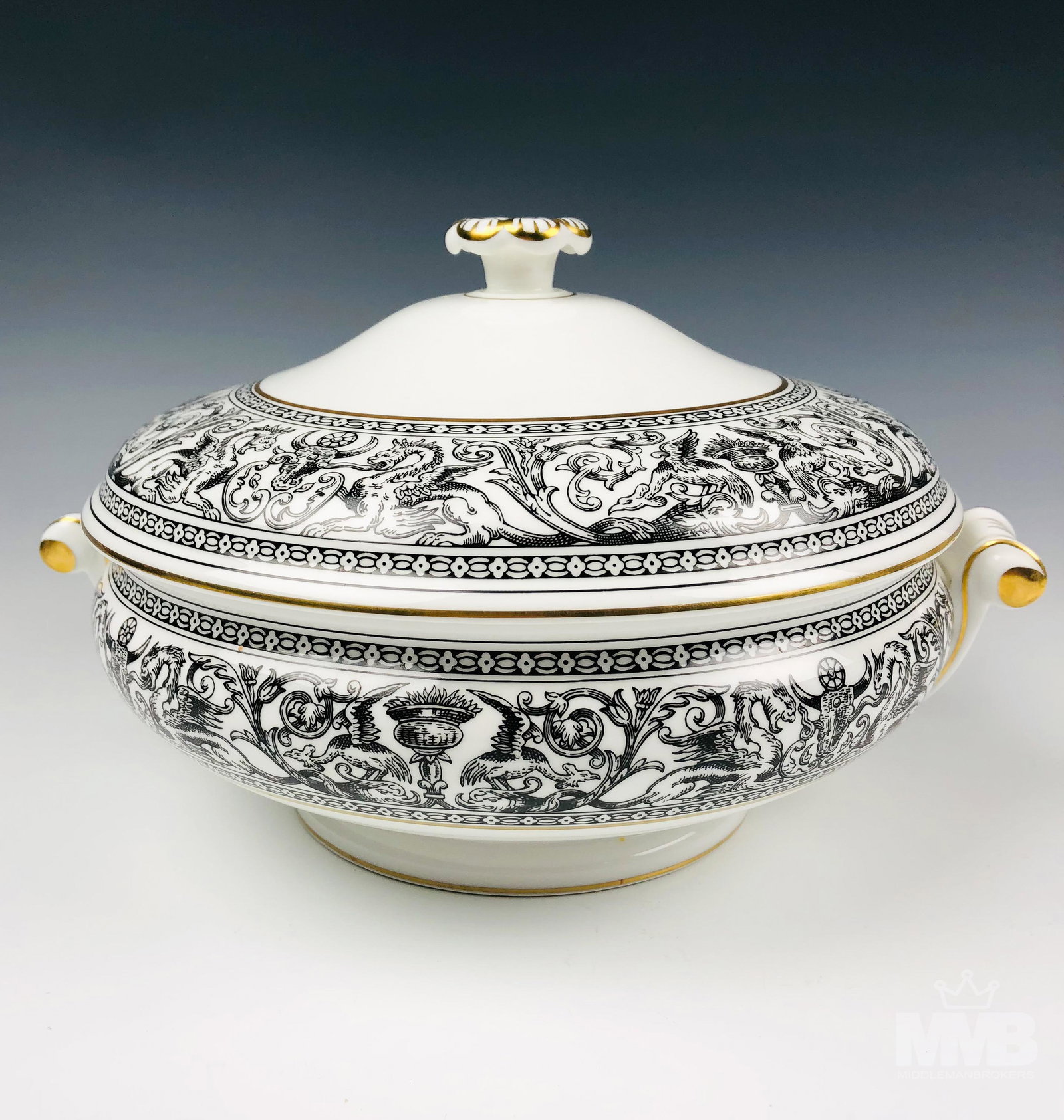 Wedgwood Florentine Black Round Covered Vegetable: Graced with mythological dragons, phoenix birds and floral decorations around the border of both the domed lid and the body, against a crisp white ground with gold trimmed linings. Scroll designed han