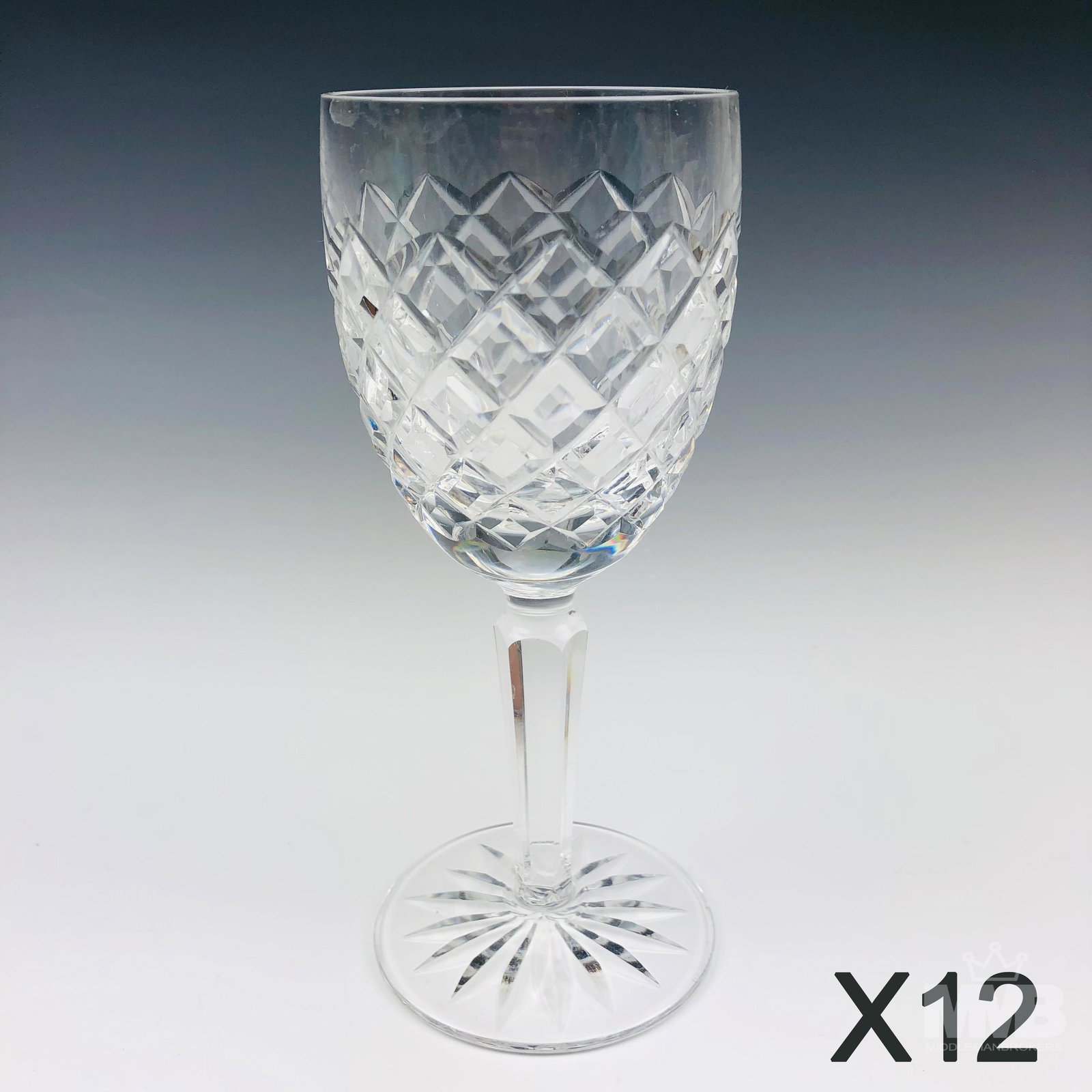 12 Waterford Crystal Comeragh Claret Wine Goblets: Design features a cut diamond quilted pattern around the body over a circular base with star burst design to the underside. Production years : 1974 - 2017. No box. Good estate fresh condition. No chip