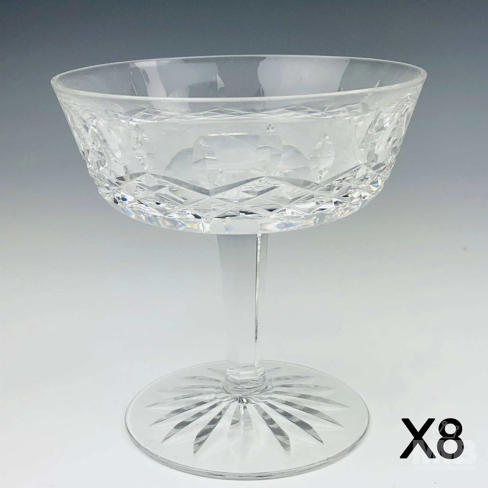Set 8 Waterford Crystal Lismore Champagne Sherbets: Modeled by Waterford in their popular Lismore pattern introduced in 1957. Each graced with vertical cuts over a diamond quilted body. Cut star burst to the underside. Sparkling clarity. No box. Good e