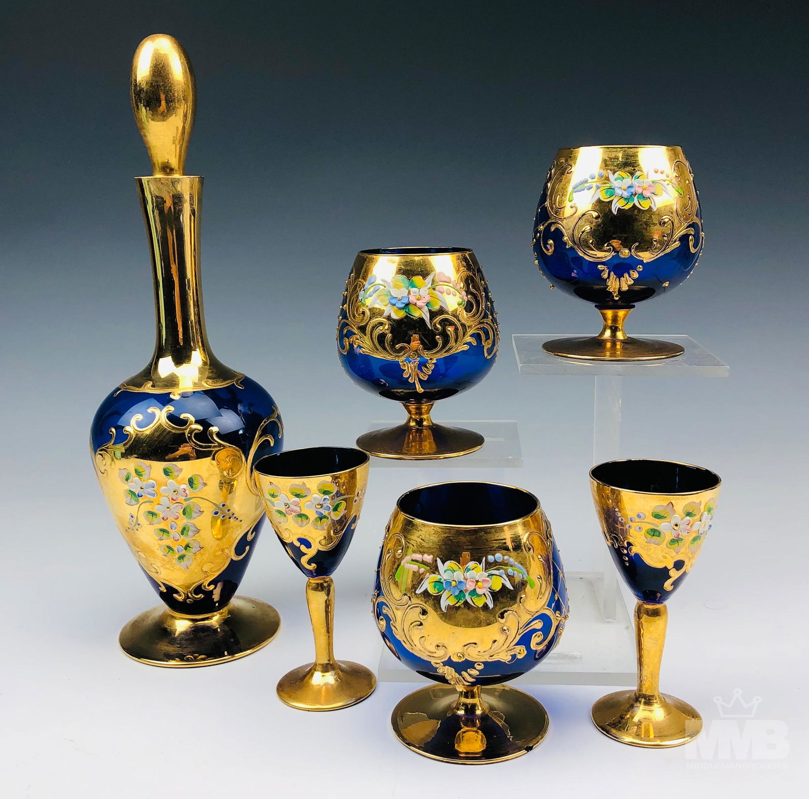 Bohemian Czech Cobalt Gold Gilt Decanter & Goblets: Bohemian Czech crystal cobalt blue art glass stoppered liquor decanter, 3 brandy snifters & 2 sherry / port wine glasses. All graced with painted raised enamel decorations embellished with rich gold a