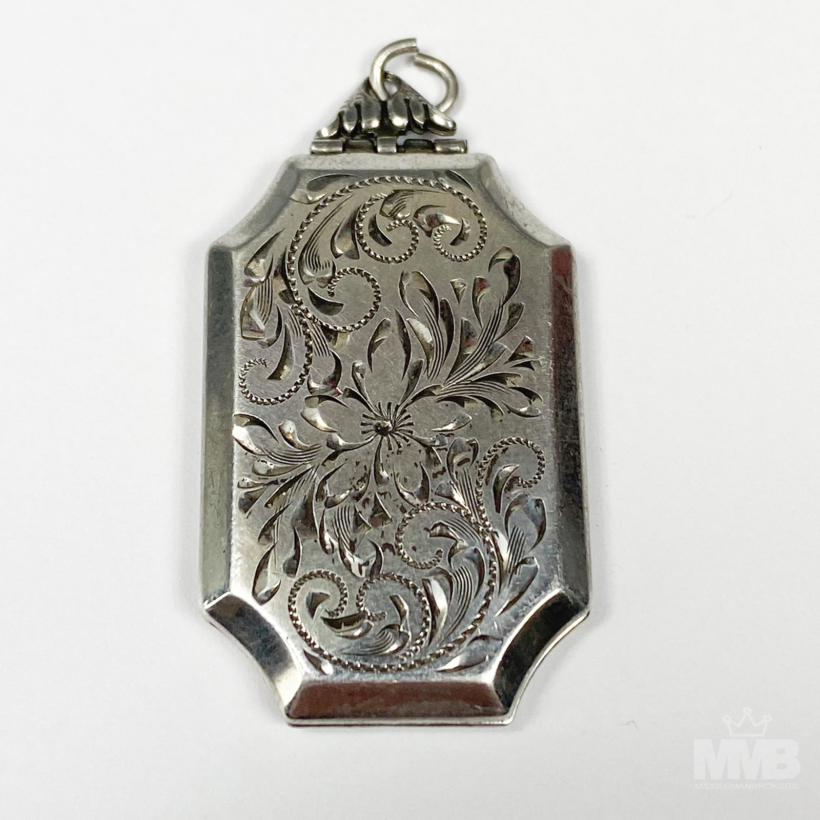 Sterling Silver Designer K.B. Etched Photo Locket: Vintage sterling silver photo locket pendant. Features etched floral design. Hinges for opening and closing. Signed "K.B. Sterling". Measures approximately 1 3/4 in. x 3/4 in. x 1/2 in. Good condition