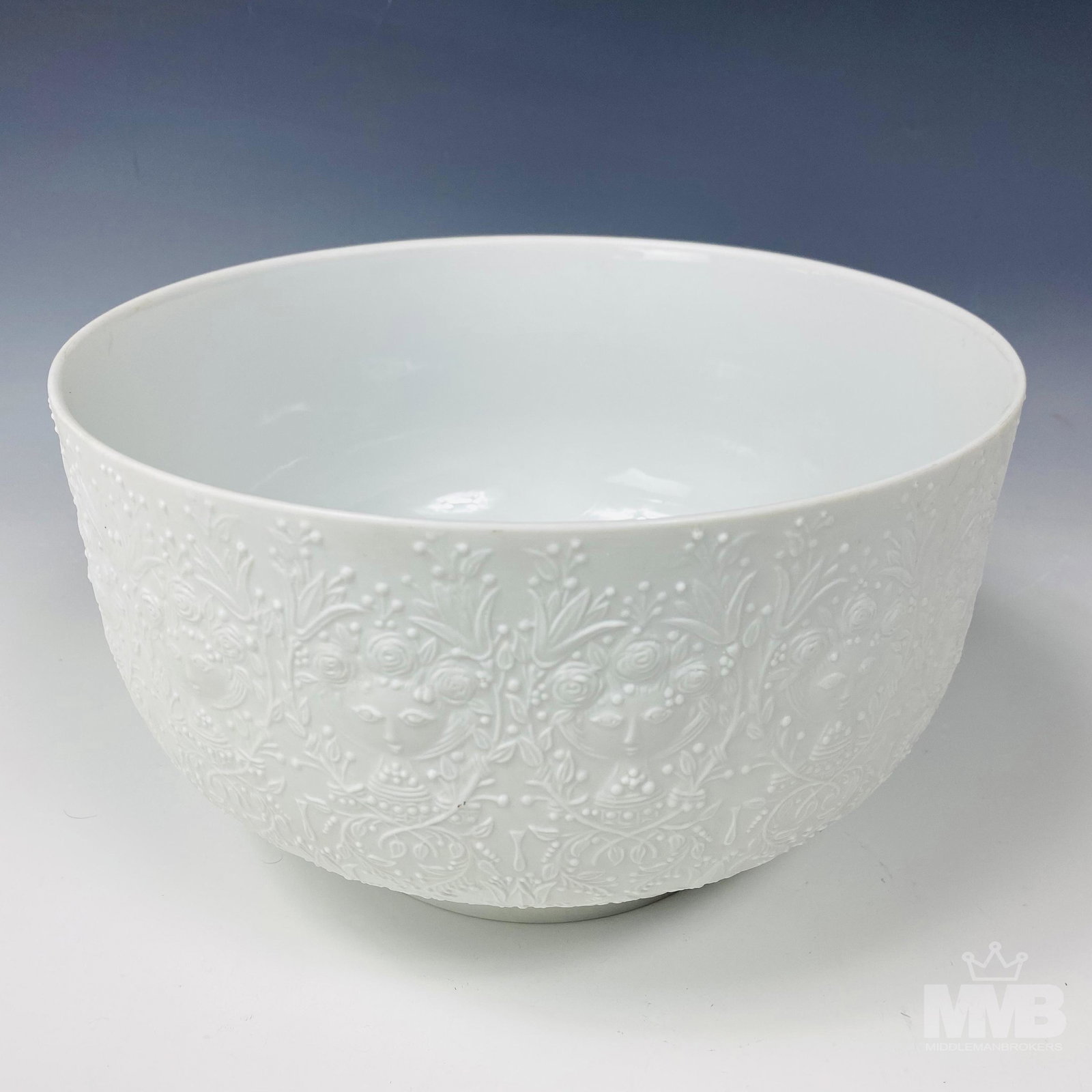 Rosenthal Bjorn Wiinblad Porcelain Fantasy Bowl: Rosenthal Bjorn Wiinblad porcelain fruit bowl. The exterior is embellished with a matte, bisque, embossed figural motif of women enveloped by flowers and foliage. Marked on underside. Good overall con