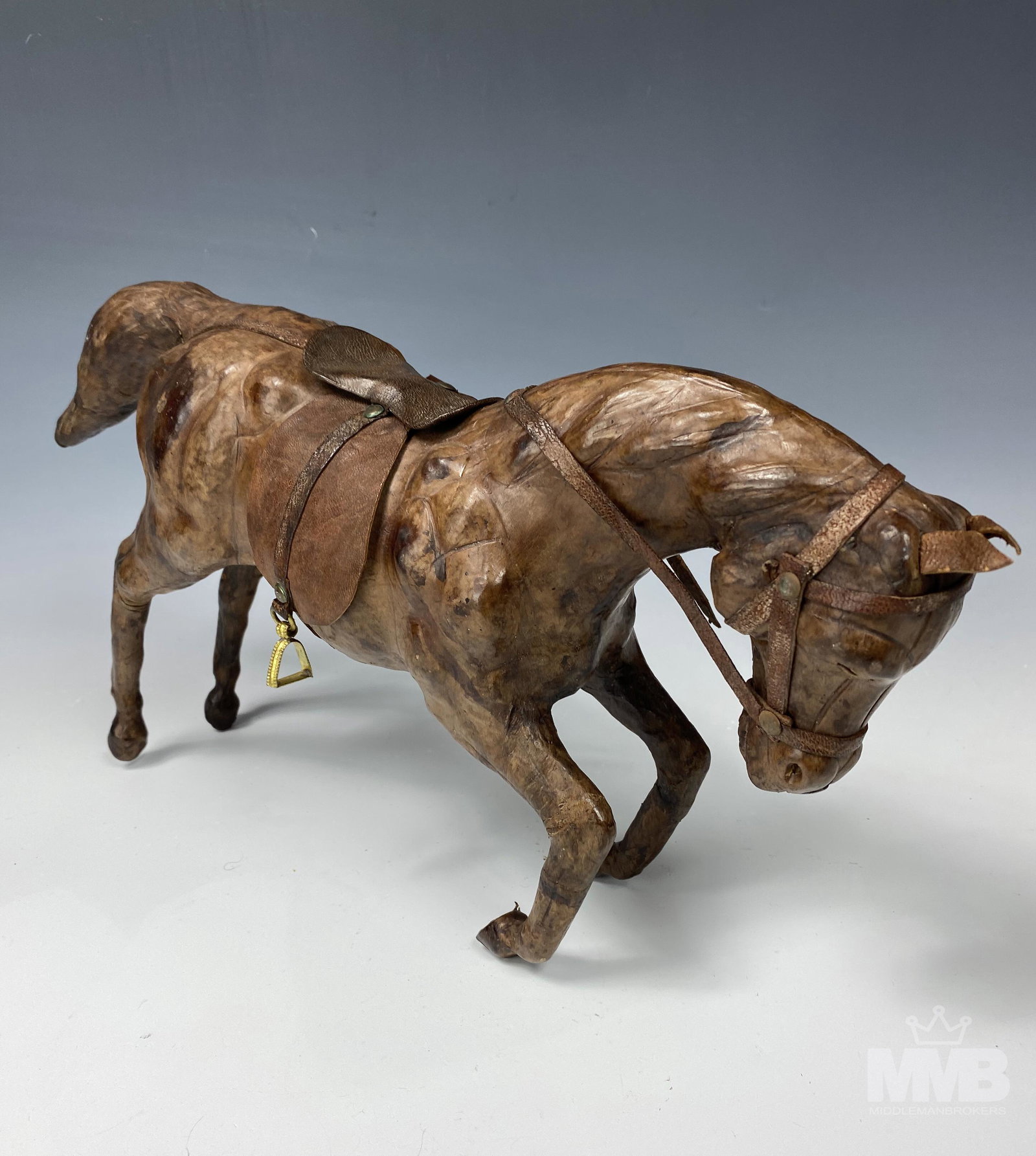 Folk Art Tooled Brown Leather Horse Sculpture: Folk art tooled leather horse statue. Good overall condition with mild storage wear. Measures approximately 9 in x 19 in x 4 in. MMB in house USA continental shipping $55 plus insurance. Gallery will 