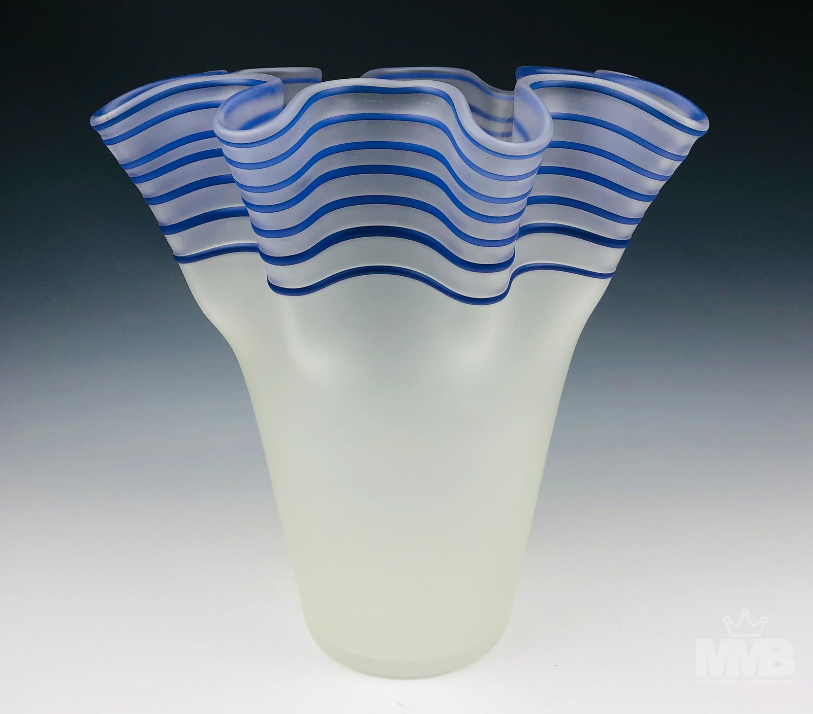 Modern 14" Studio Art Glass Ruffed Threaded Vase: Frosted art glass vase with blue threaded design and ruffled rim. Good condition with minor wear. Measure 14 1/2 in x 13 1/2 in x 13 1/2 in. MMB, Inc. will not ship. Gallery will refer local shipper f