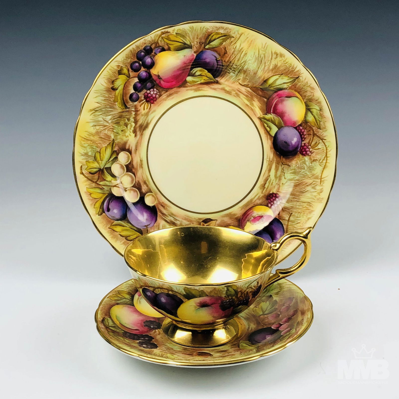 Aynsley Orchard Gold Tea Cup Saucer & Salad Plate: Graced with a plentiful harvest motif scene featuring ripened luscious fruits, berries and nuts against a cream ground. Borders, cup interior and saucer rest embellished with rich gold accent linings.