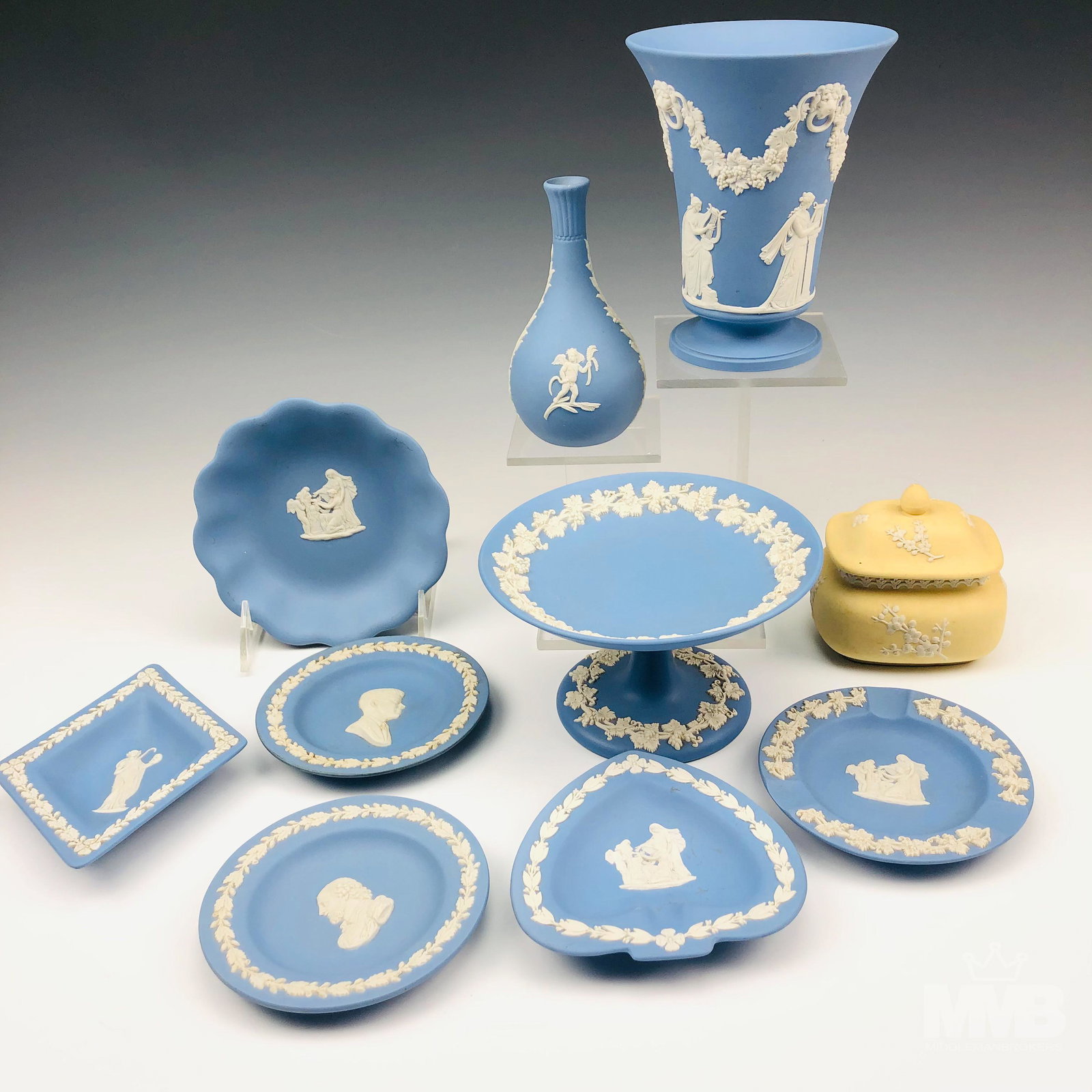 Wedgwood Blue Jasperware LOT Vase Compote Dishes: This Wedgwood English blue jasperware lot includes the following articles ~ 1 x vase, 1 x compote. 1 x scalloped dish tray. 2 x small dishes. 1 x diamond shaped dish. 2 x ashtray bowls. 1 x bud vase. 