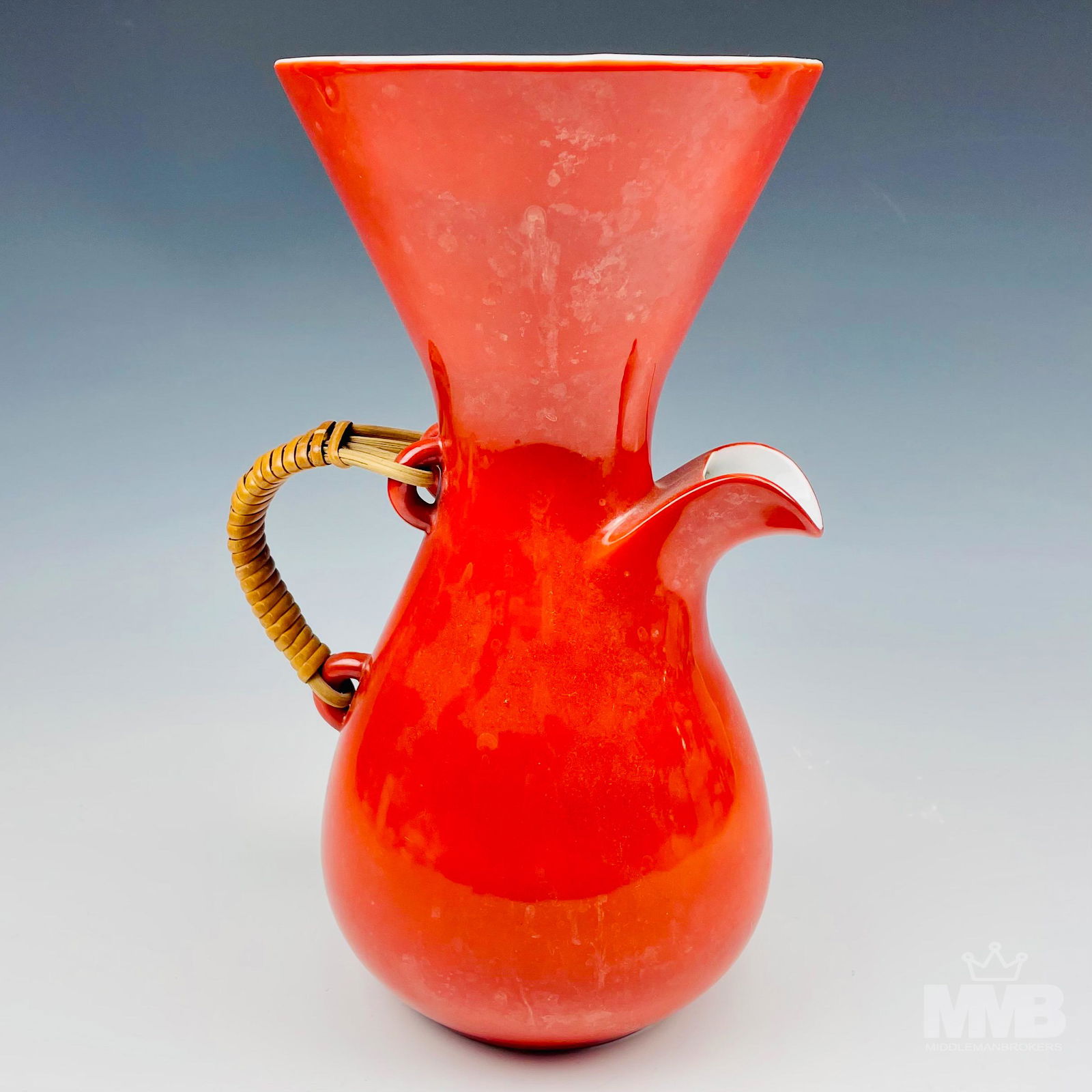 Kenji Fujita Mid Century Porcelain Coffee Carafe: Japanese modernist coffee pitcher pot designed in the 1950's by Kenji Fujita for Freeman Lederman, an American ceramic manufacturer. Classic hourglass design with rattan wicker handle. Bright persimmo