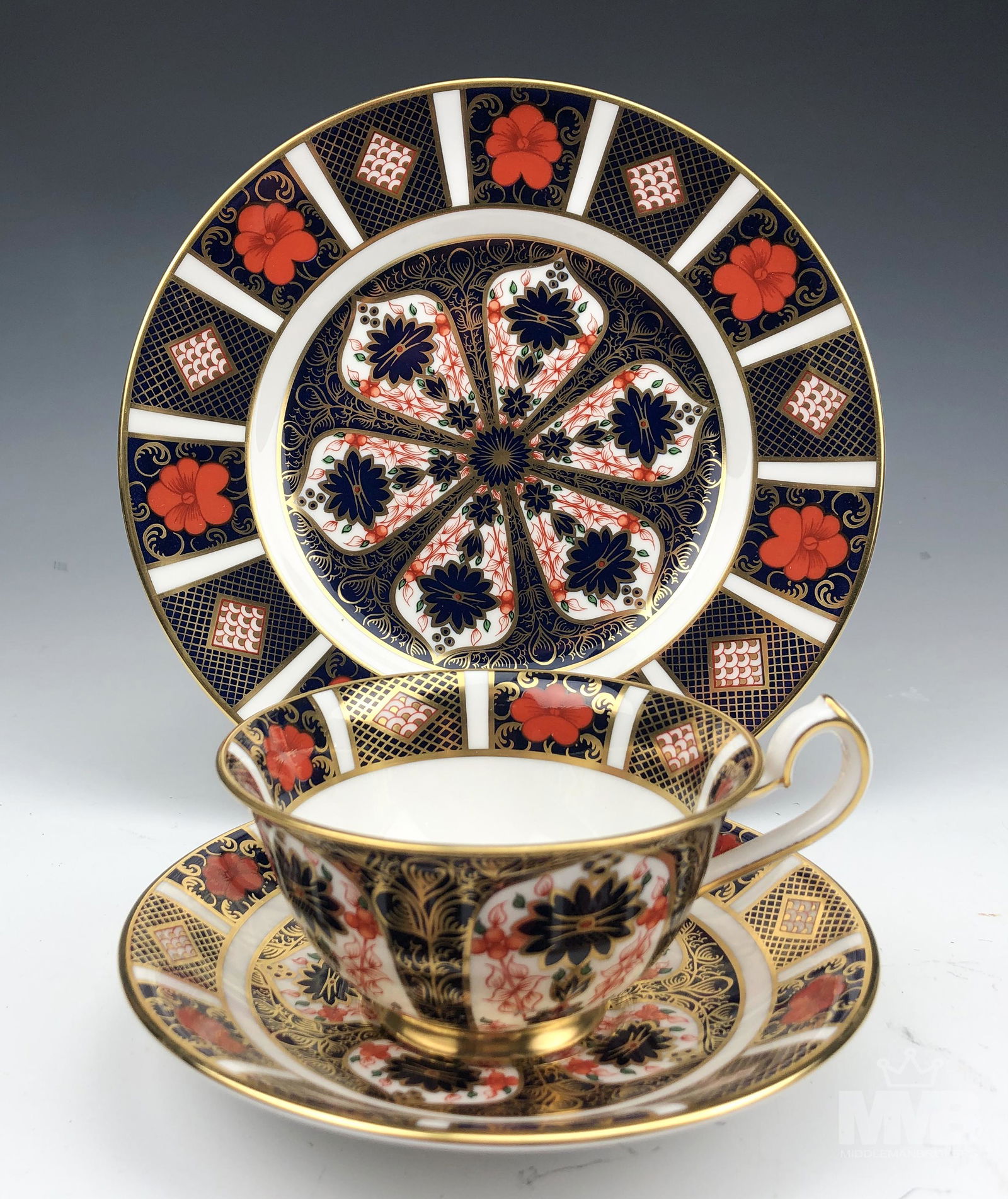 Royal Crown Derby Old Imari Cup Saucer Plate Trio: English bone china tea cup, saucer and salad plate trio set. Modeled in the "Old Imari" pattern that was introduced in 1901. Graced with designs of rich orange reds and cobalt blues against a crisp wh