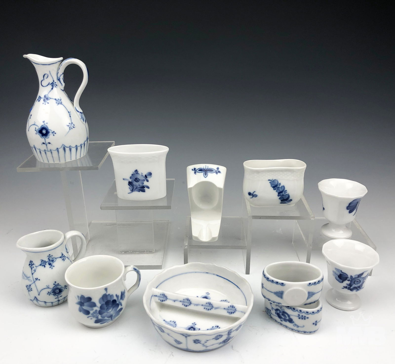 Royal Copenhagen Bing Grondahl Assorted Lot 11 pc: Assortment of Danish porcelain articles from Royal Copenhagen and Bing and Grondahl. Includes toothpick holder, spoon rest, small divided dish, egg cups, napkin rings and mini creamers. All feature a