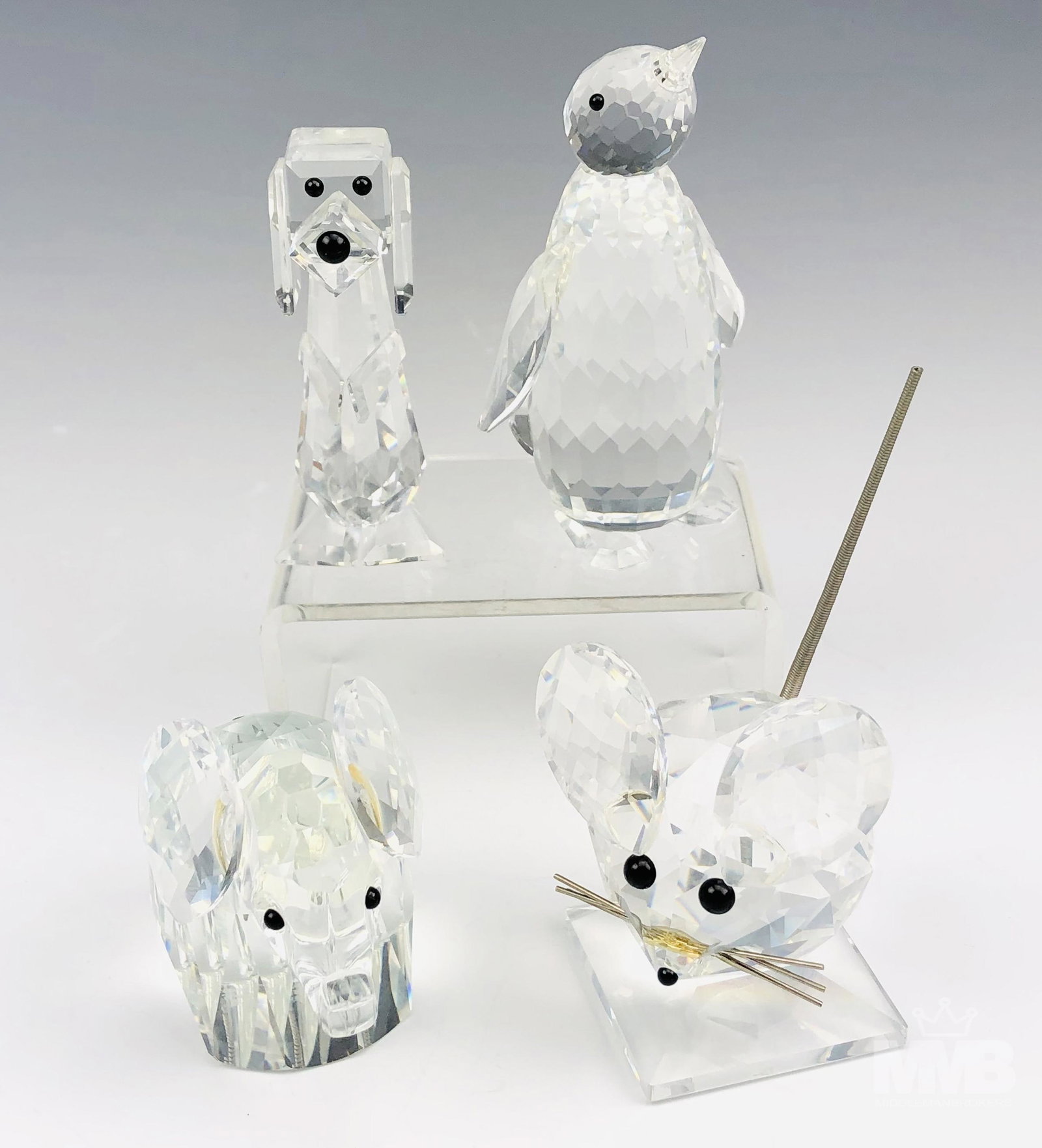 Estate Lot of 4 Swarovski Crystal Animal Figurines: Swarovski crystal animal sculpture lot includes: (1) elephant with a floppy metal tail from the African Wildlife collection. Measures 2" x 3" x 1.5"; (1) penguin from the Kingdom of Ice and Snow colle