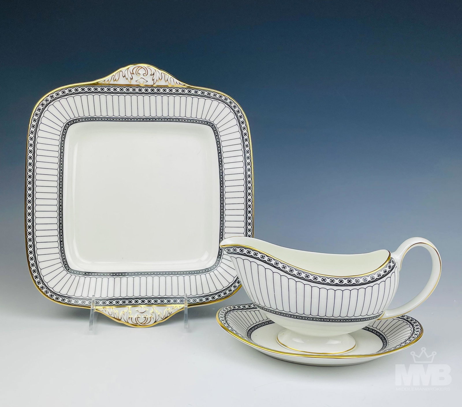 Wedgwood Black Colonnade Cake Plate & Gravy Boat: Design features black geometric lines and floral rosette forms around the rims, the borders with a rich gold trim lining. Production years : 1960 - 2004. Glazed finish. The gravy boat measures 4 in. x