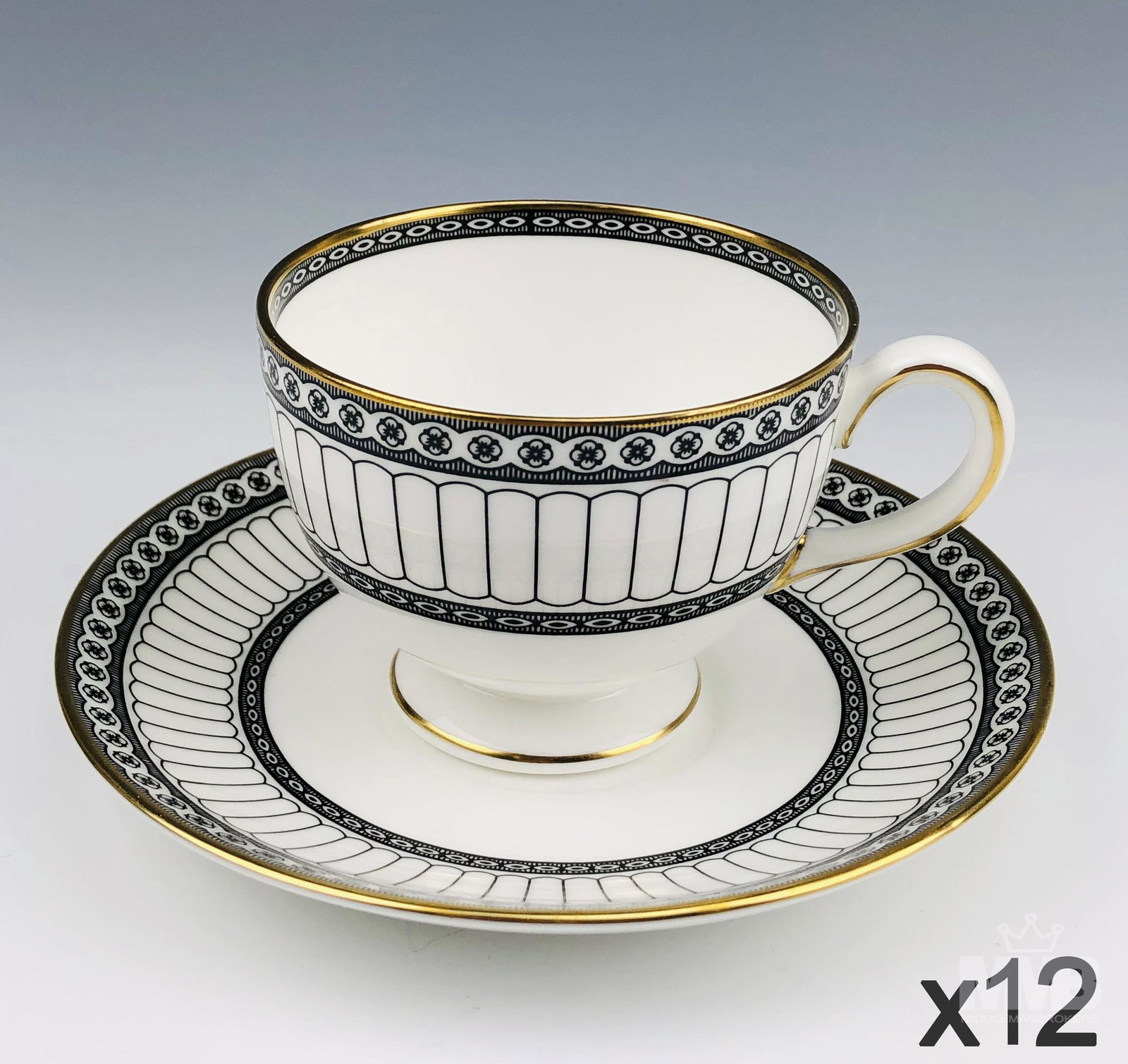 12 Wedgwood England Black Colonnade Teacup Saucers: Design features black geometric lines and floral rosette forms around the rims, the borders with a rich gold trim lining. Production years : 1960 - 2004. Glazed finish. Cups measure 2 1/2 in. x 3 1/4 