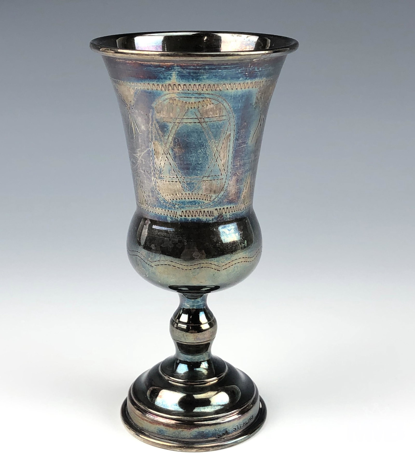 Sterling Silver Jewish Judaica Kiddush Wine Cup: Graced with 3 engraved oval cartouches, one featuring the Star of David, one with a leaf pattern and one being blank. Nicely footed in manner with circular stepped base. All original weathered and age