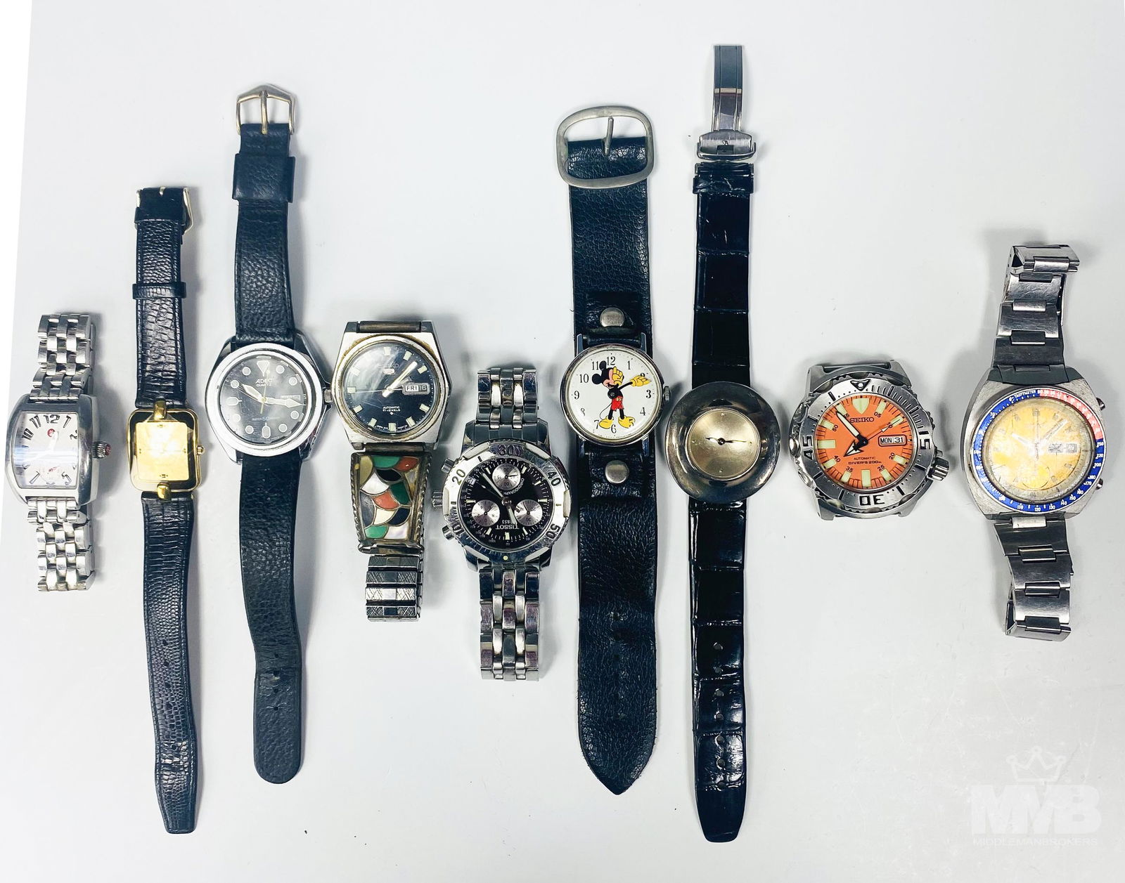 Lot 9 Seiko Tissot Adec Rado Men's Wrist Watches: Includes 3 x Seiko, 1 x Tissot, 1 x Adec, 1 x Michele, 1 x Robert Lee Morris, 1 x Rado & 1 x Mickey Mouse. Only the orange dial face Seiko watch is working. The others do not / are not working. Being