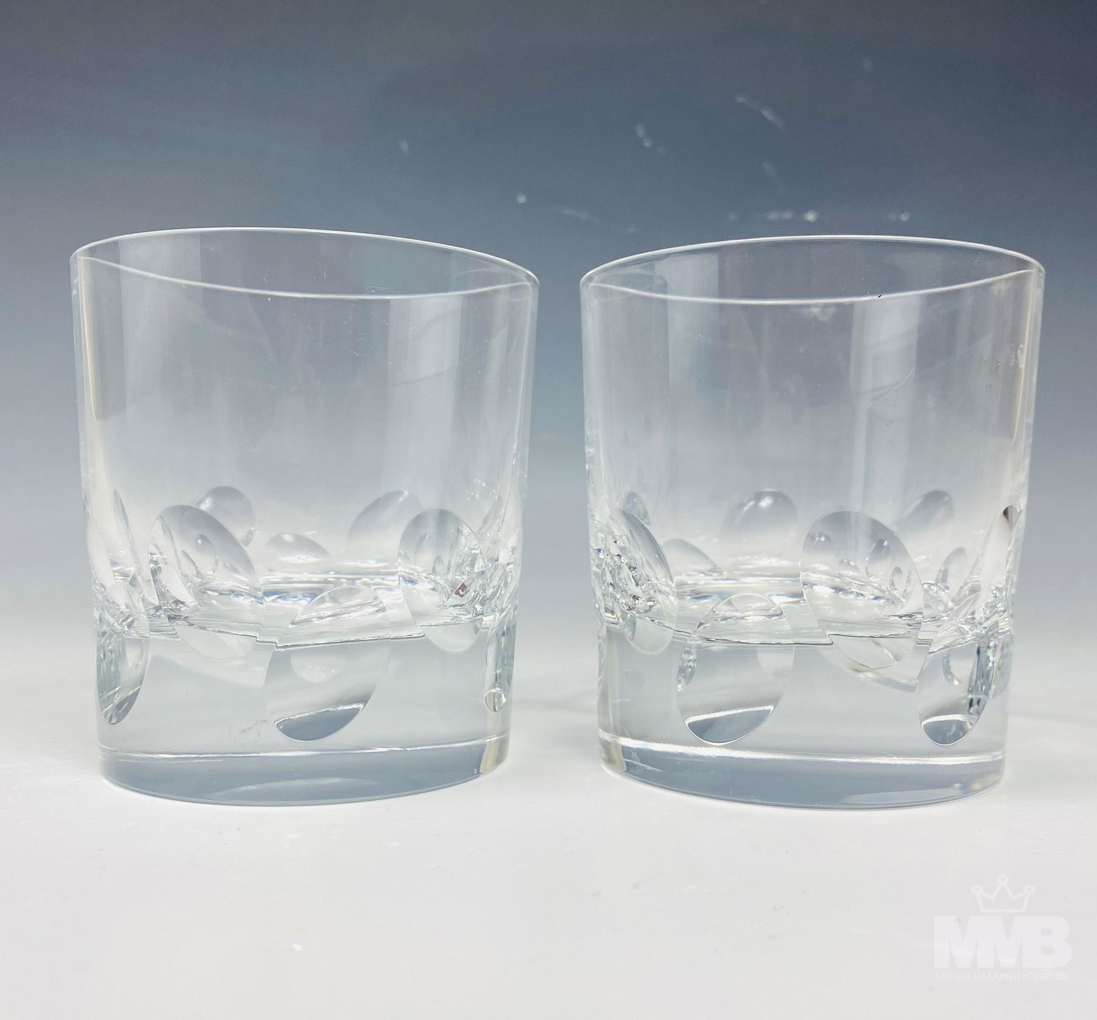 Pr Christofle "Cluny" Double Old Fashioned Glasses: Manufactured by Christofle in their "Cluny" pattern that was introduced in 1999. Design features slanted oval concaves in a wave manner, around the base. Smooth high mirror polished finish to the unde
