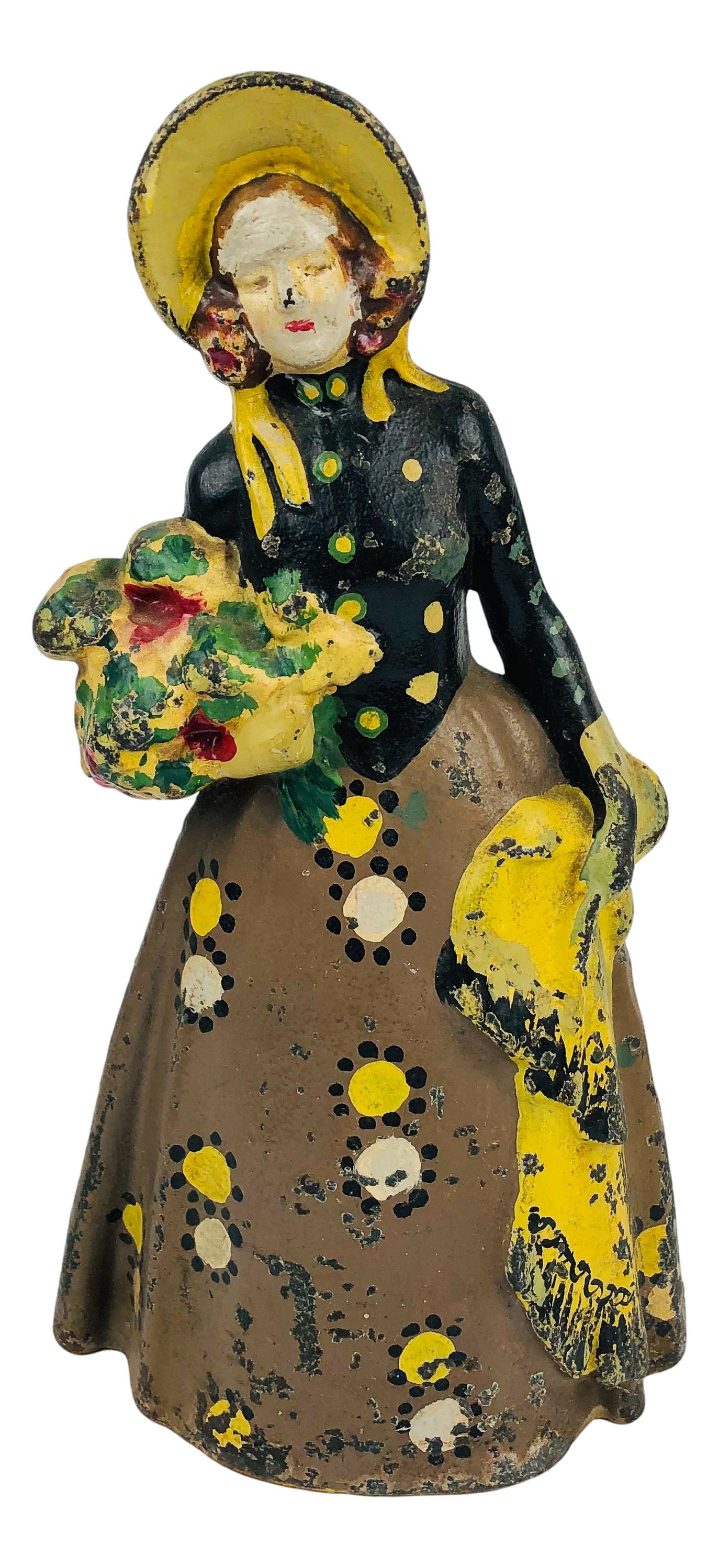 Cast Iron Woman with Flowers and Shawl Doorstop: Door stop crafted out of cast iron depicting a woman with Flowers. Marked #42 on verso. No other apparent markings, being advertised in the style of Hubley and Bradley & Hubbard. SHIPPING MIDDLEMANBRO