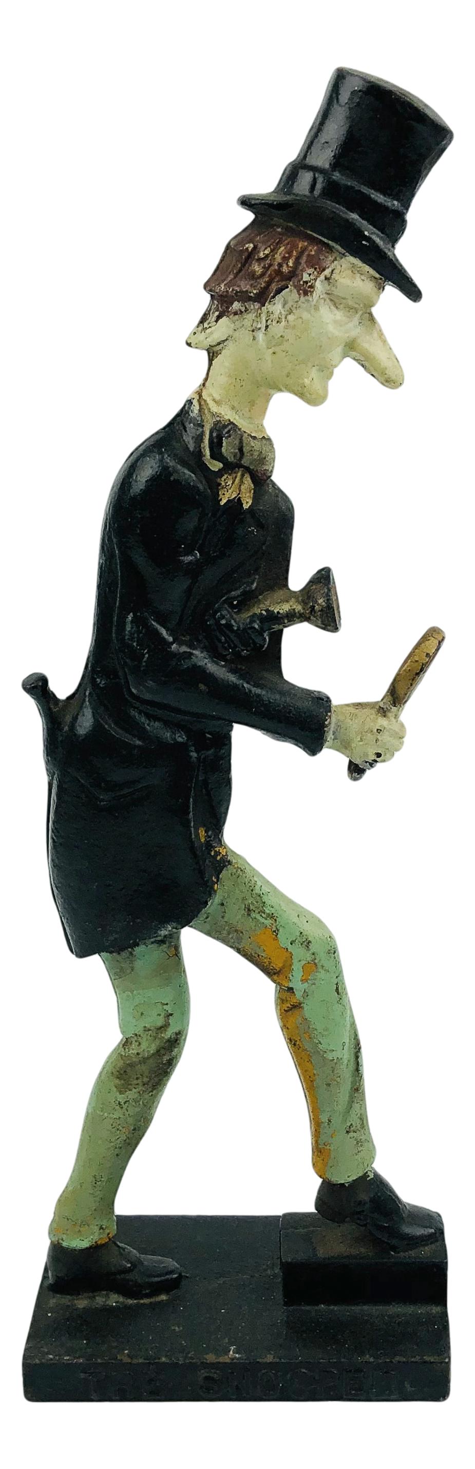 Cast Iron The Male Snooper Doorstop Figurine: Door stop crafted out of cast iron depicting man holding a flashlight in one hand and a magnifying glass in the other. Titled "The Snooper". No other apparent markings, being advertised in the style o