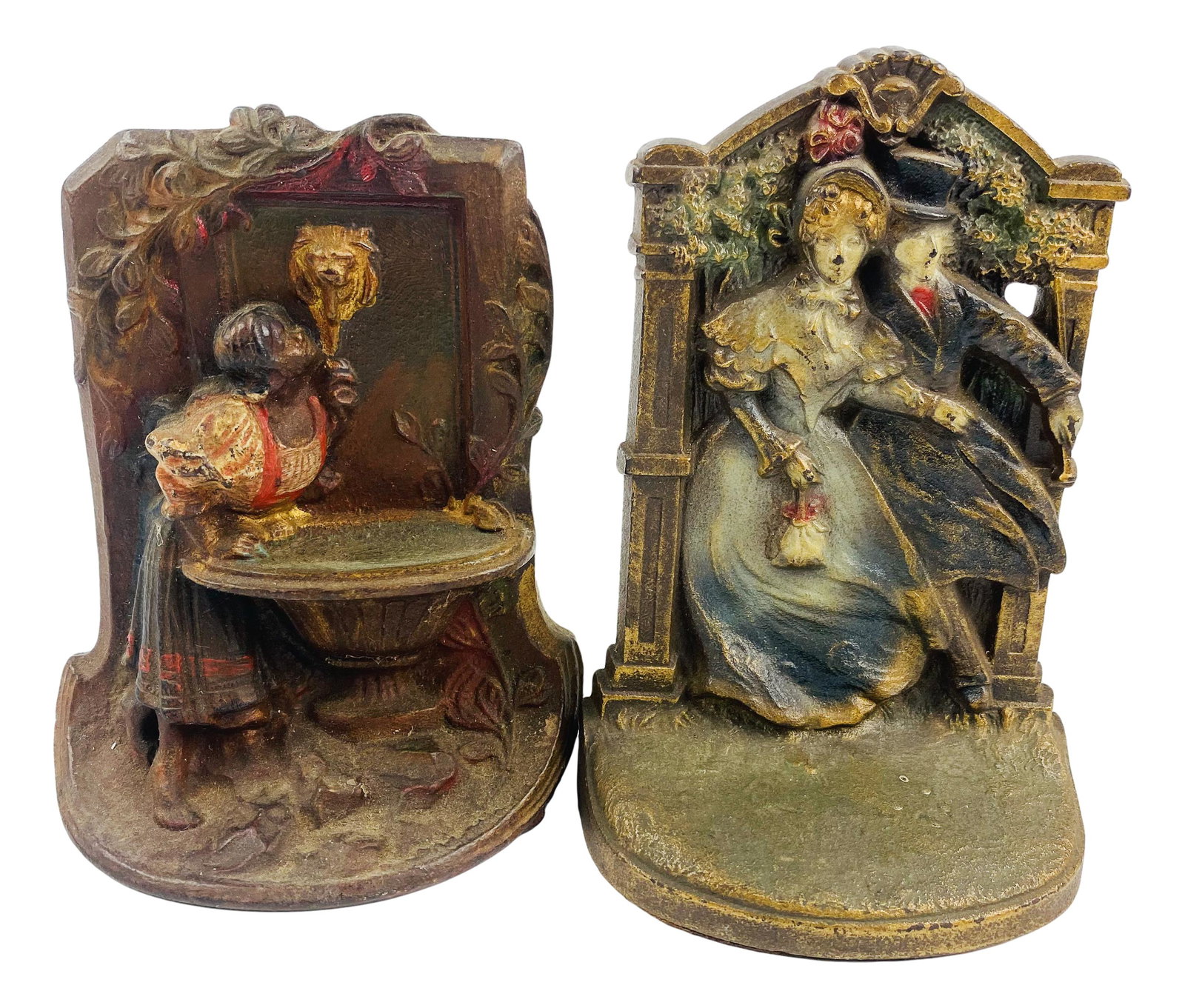 Lot Cast Iron Maiden Fountain & Figural Doorstops: Cast iron door stops or bookends. Lot includes:(1) . Victorian man and woman measuring 6.5" x 4" x 2". Marked with inventory 09662 on verso and (1) Maidens fountain measuring 6" x 4.5" x 2"; No other