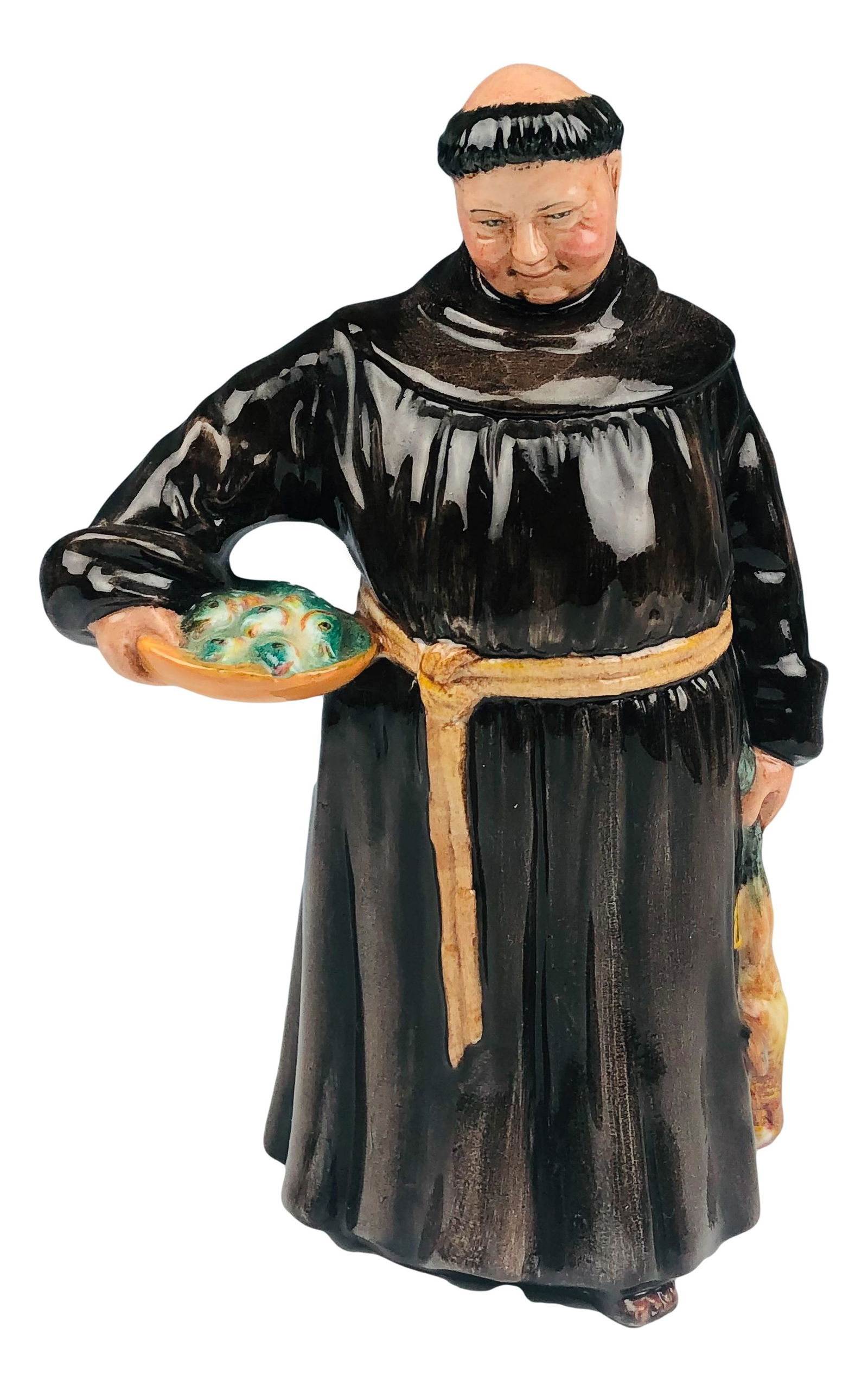 Royal Doulton The Jovial Monk HN2144 Man Figurine: Designed by Peggy Davies. Production years : 1954 - 1976. Part of the Peggy Davies group themed series. Features a monk in a brown robe, holding a dead game bird in one hand, a basket of fish in the o