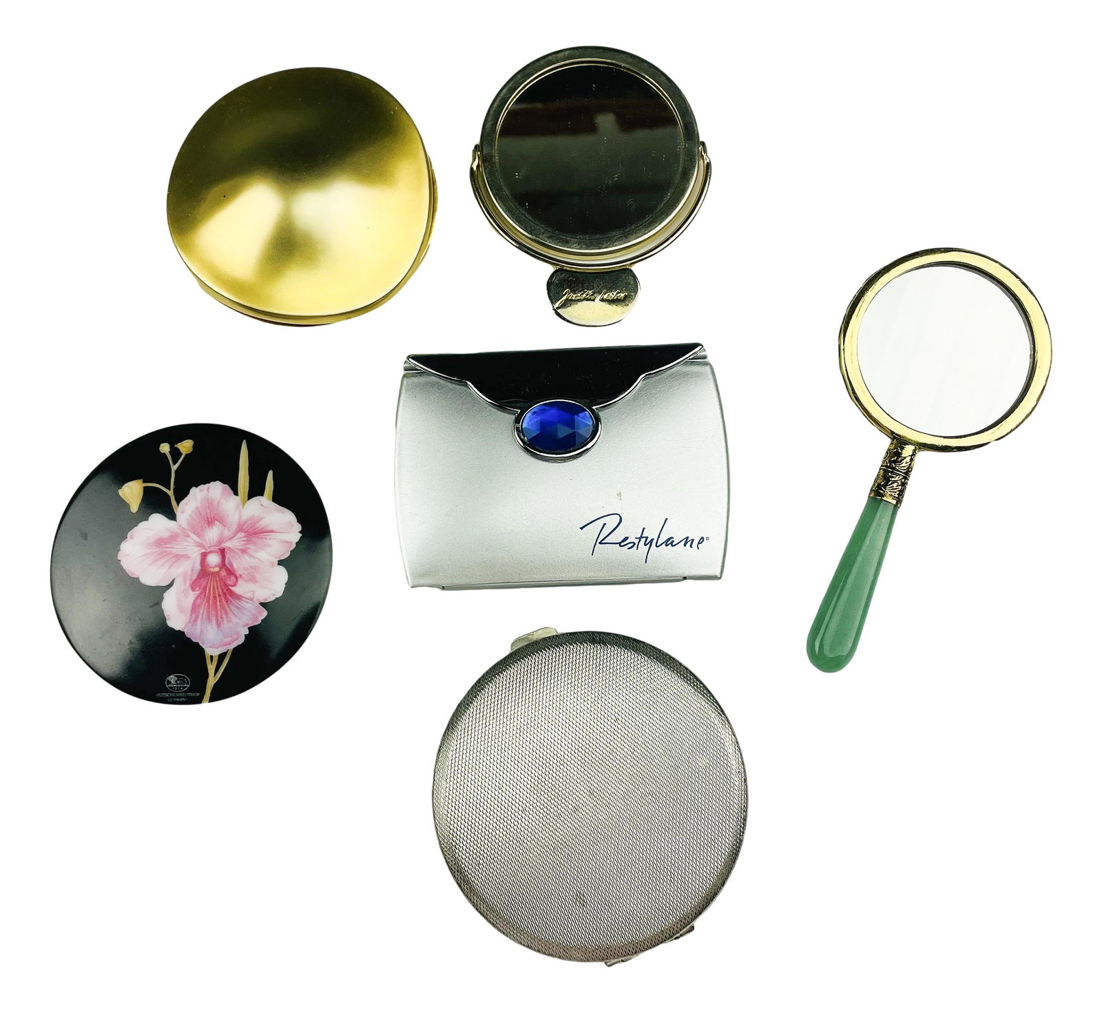 Robert Lee Morris Judith Leiber Compact Mirror LOT: Includes the following. Gold tone Robert Lee Morris for Elizabeth Arden compact. Judith Leiber swivel mirror. Bejeweled jade handle hand mirror. Restylane compact mirror. An Art Deco silver plate powd