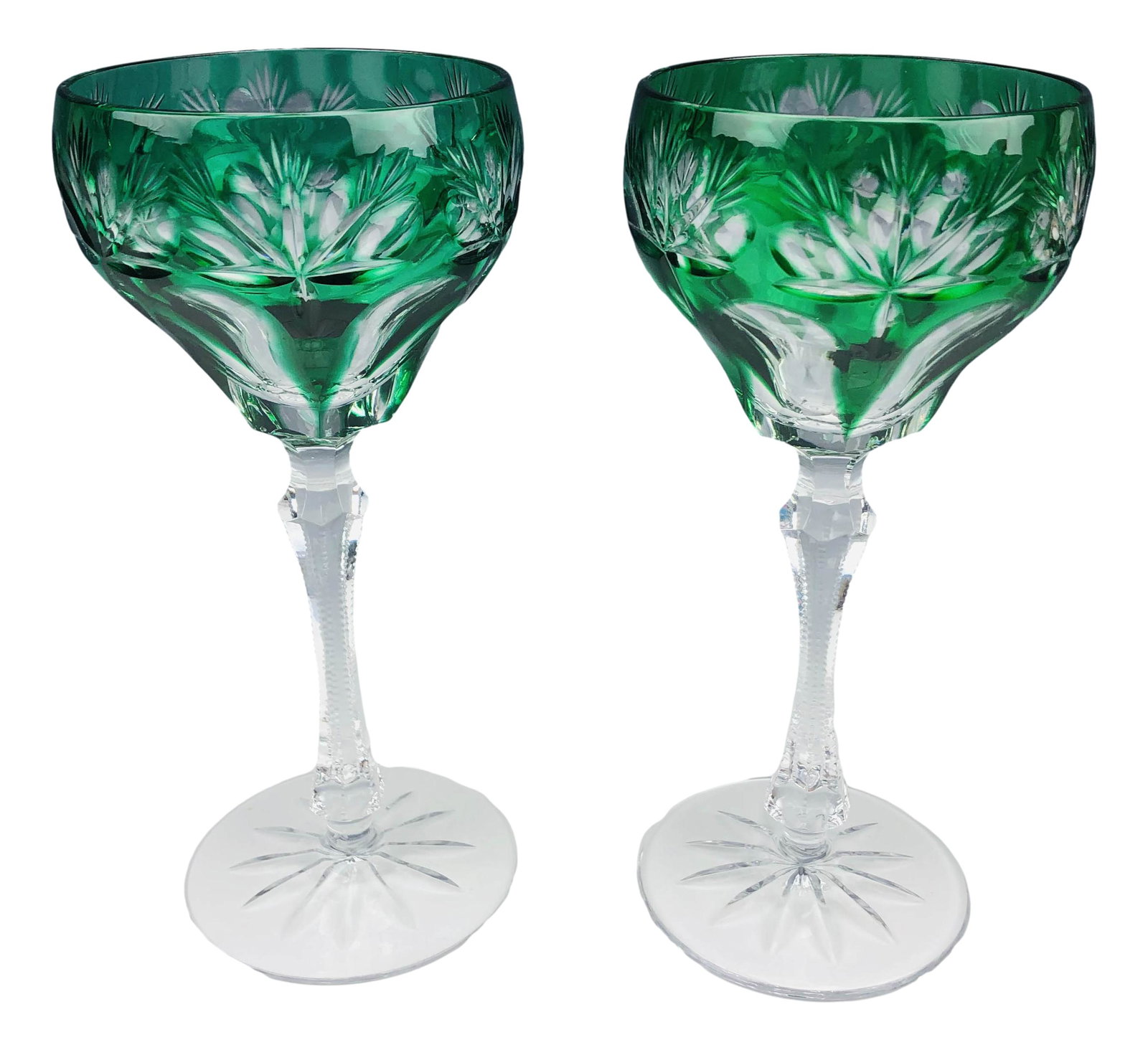 Bohemian Czech Emerald Cut Clear Wine Goblets x 2: Each crystal goblet features emerald green cut to clear designs of fans, half flowers and elongated concave panels around the bowls. Tapered stems with saw tooth pattern to the edges over circular bas