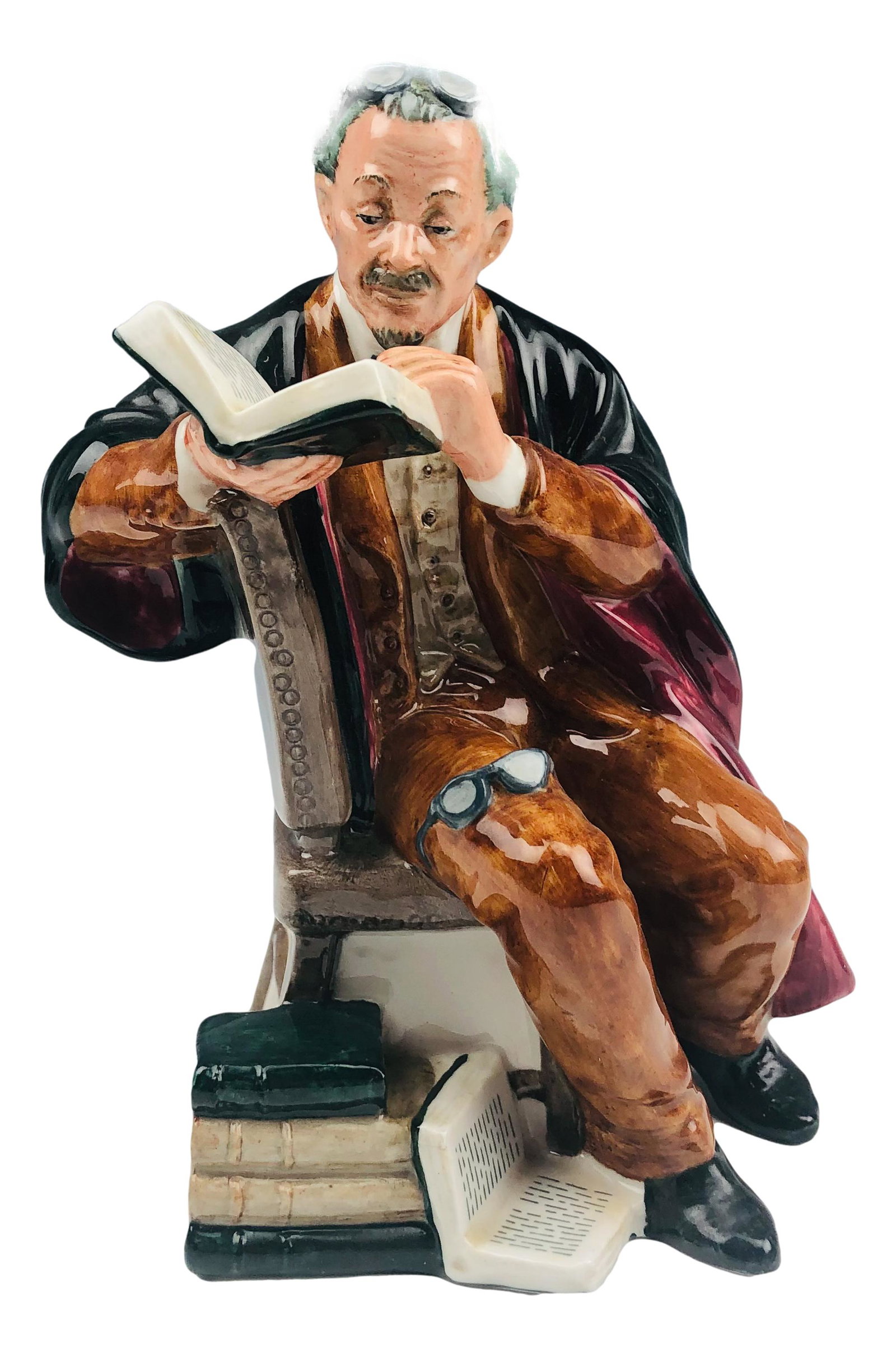 Royal Doulton The Professor HN2281 Figurine: Designed by Mary Nicoll. Production years : 1965 - 1981. Part of the Professions group themed series. Features a seated robed professor with glasses on his head and another on his knee, reading a book