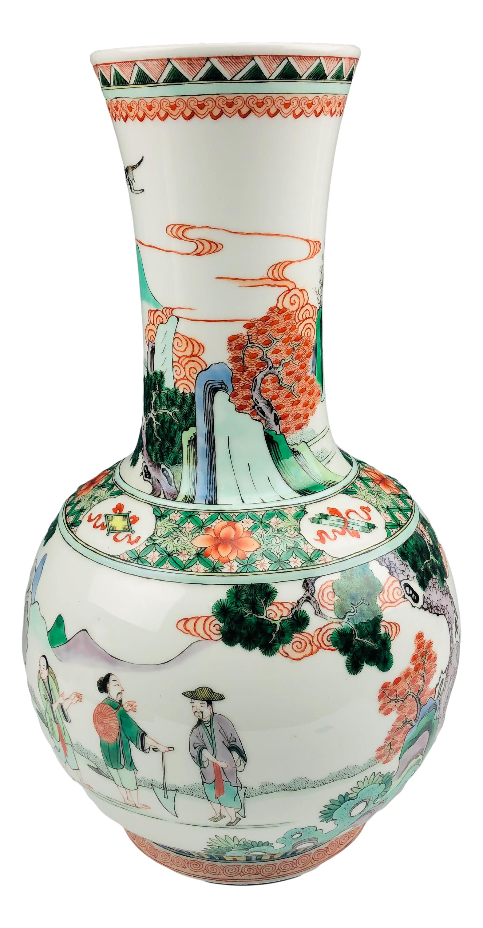 Chinese Export Famille Verte Large Porcelain Vase: Graced with a hand painted figural, elephant, bird, tree and mountain design against a crisp white ground.. Decorative bands around the mouth and base. Glazed finish. Signed with red ink chop characte