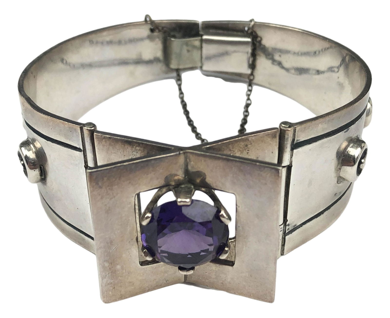 Taxco Mexico Sterling Alexandrite Modern Bracelet: Handcrafted modernist bracelet nicely center staging an alexandrite stone with graduated disc bead designs on opposites sides. Retains its original safety chain. Finished with open mouth and tongue cl