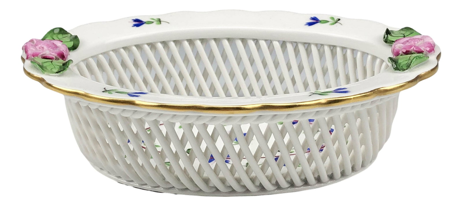 Herend Porcelain Open Weave Floral Oval Basket: Features a hand painted Hungarian porcelain oval open weave basket. Features blue flowers with applied pink and green leaf flowers on the rim border. Body with a reticulated pierced pattern. Glazed fi