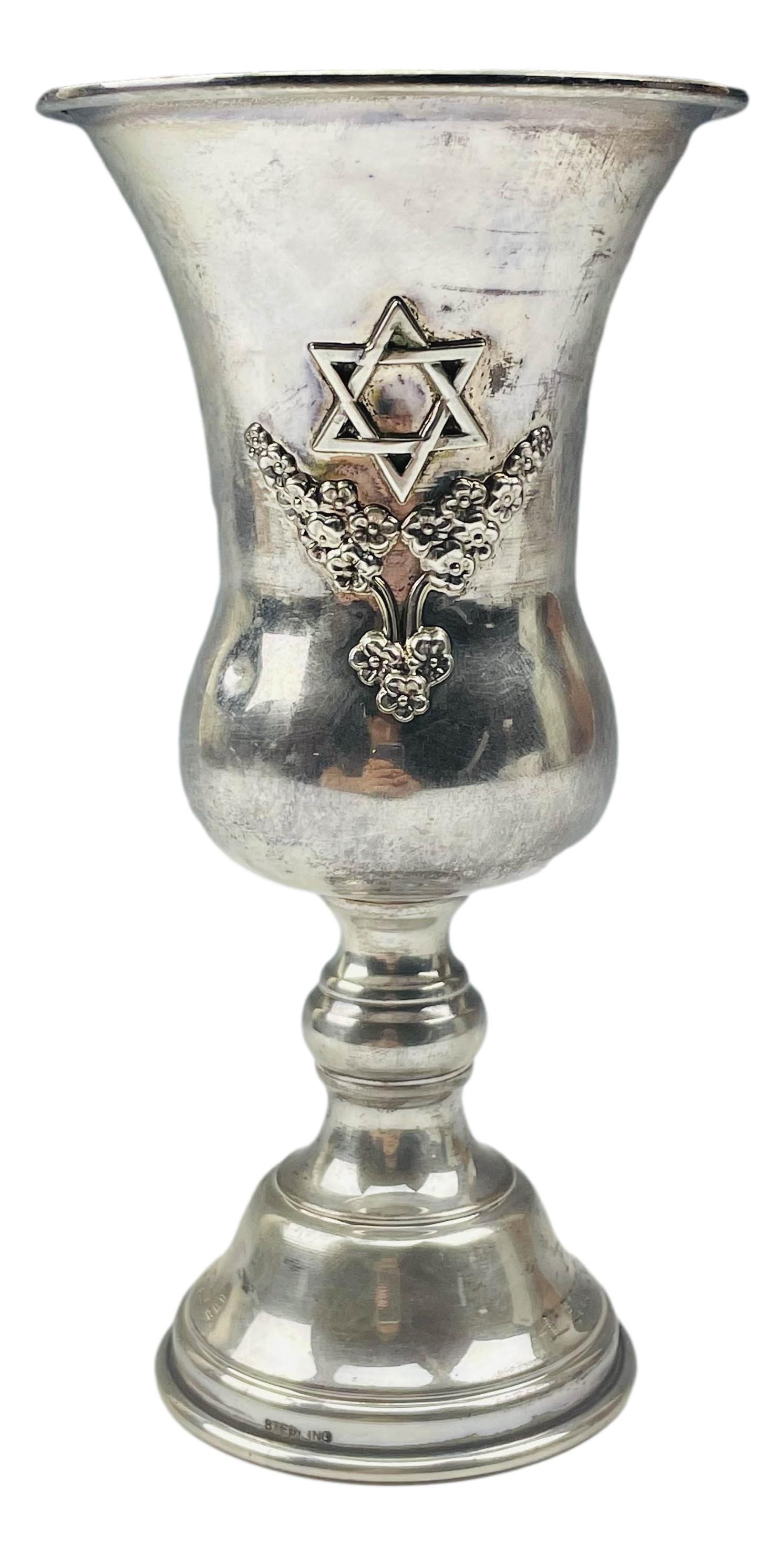 Sterling Silver Jewish Judaica Kiddush Wine Goblet: Graced with a raised 3 dimensional Star of David and a floral form below on one side, opposite side with a raised relief garland decoration. Monogrammed on the foot area ~ Robert Maisel President Men'